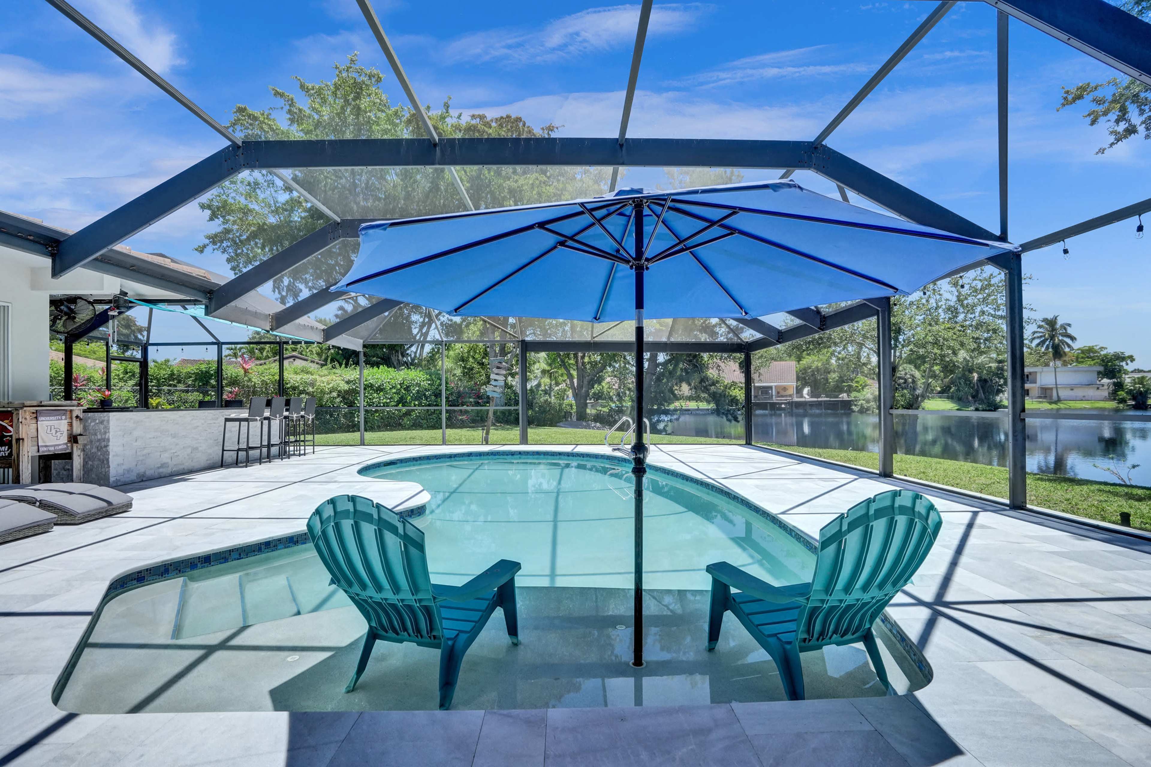 Stunning and peaceful backyard on the lake with a spacious outdoor kitchen Image in Plantation, Plantation, FL
