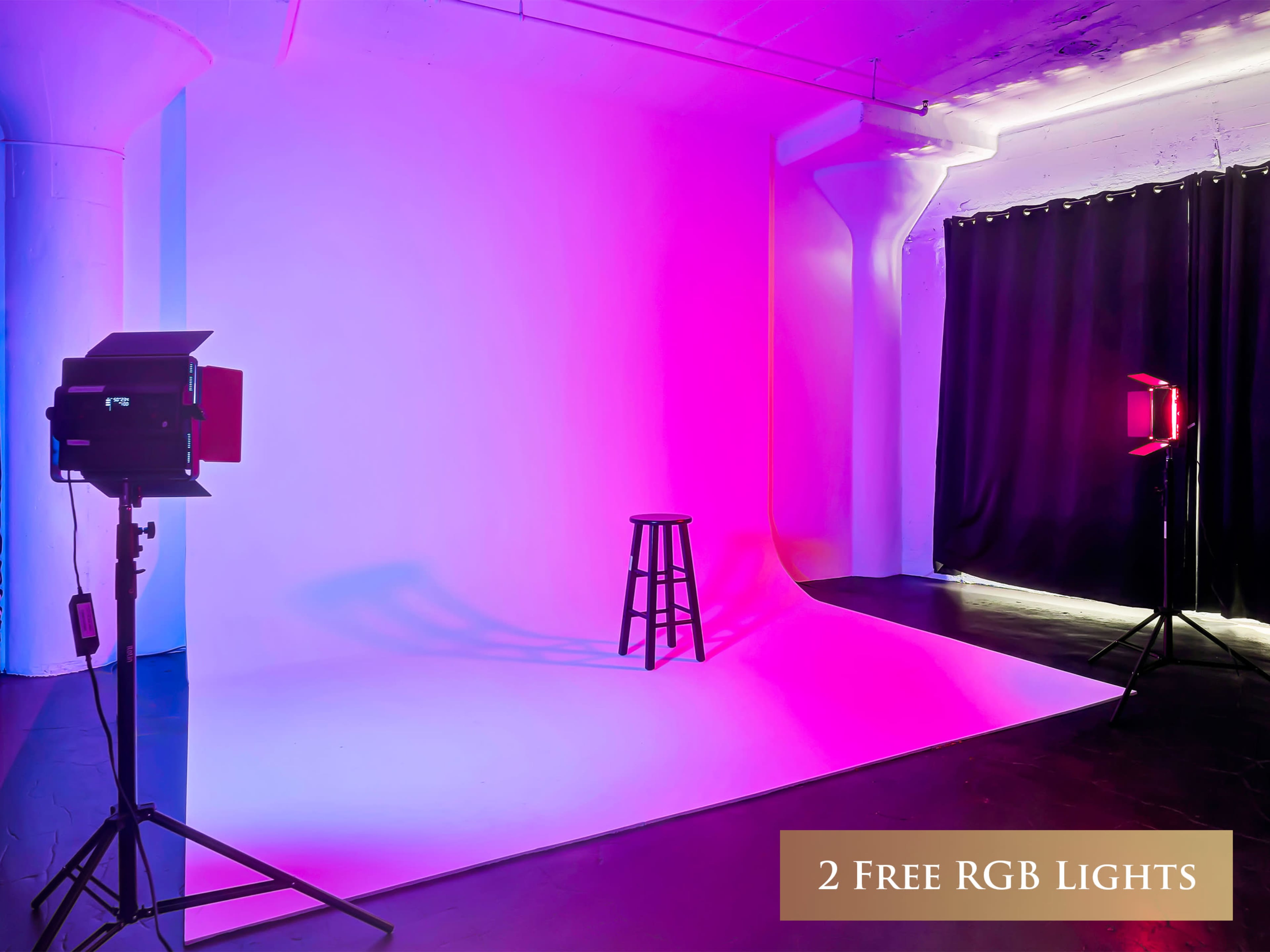 The image shows a photography studio with a colorful backdrop, a stool positioned in the center, and two RGB lights illuminating the scene from either side.