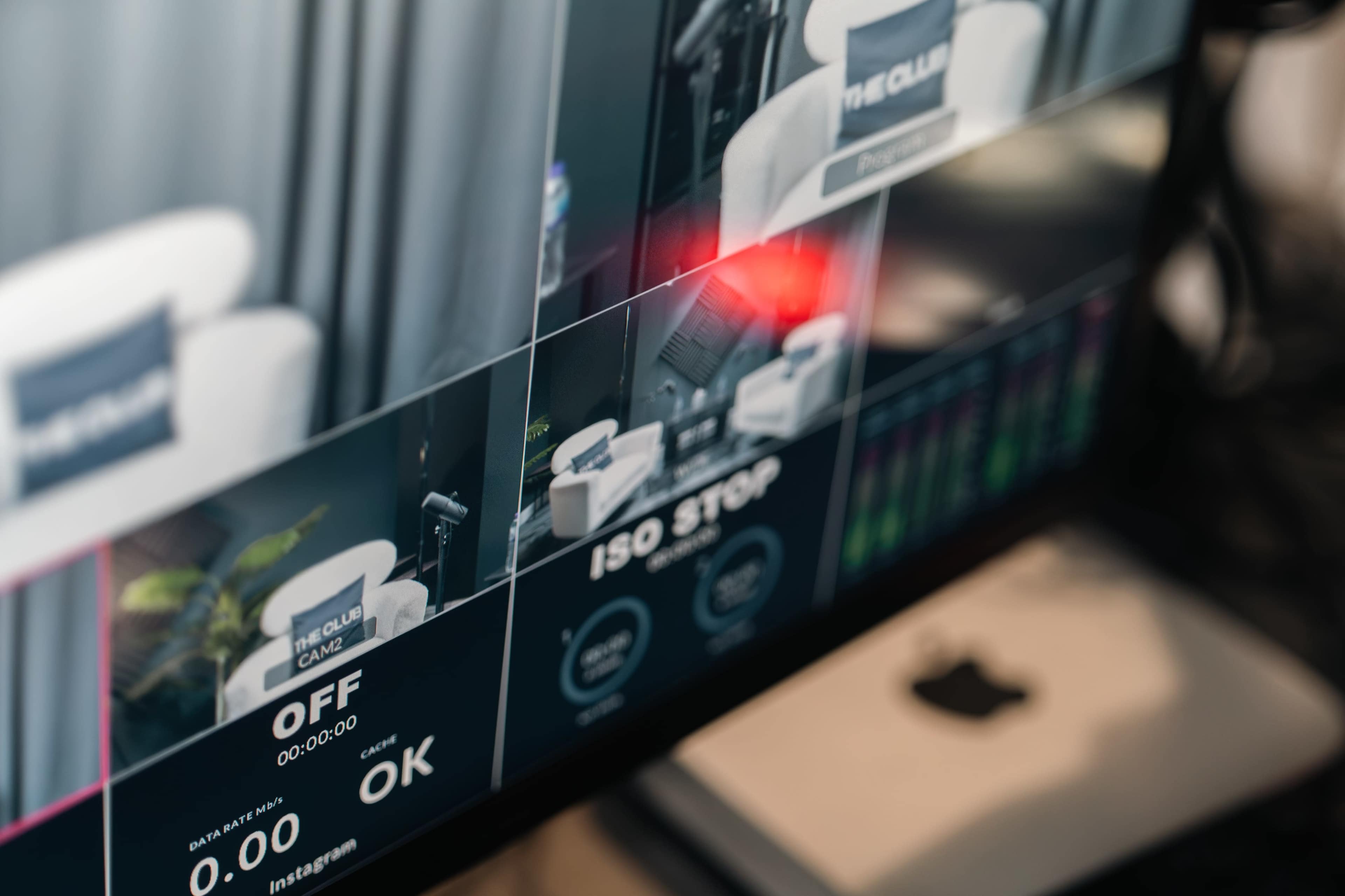 The image shows a close-up of a monitor displaying settings for a video recording, including options for ISO and status indicators.