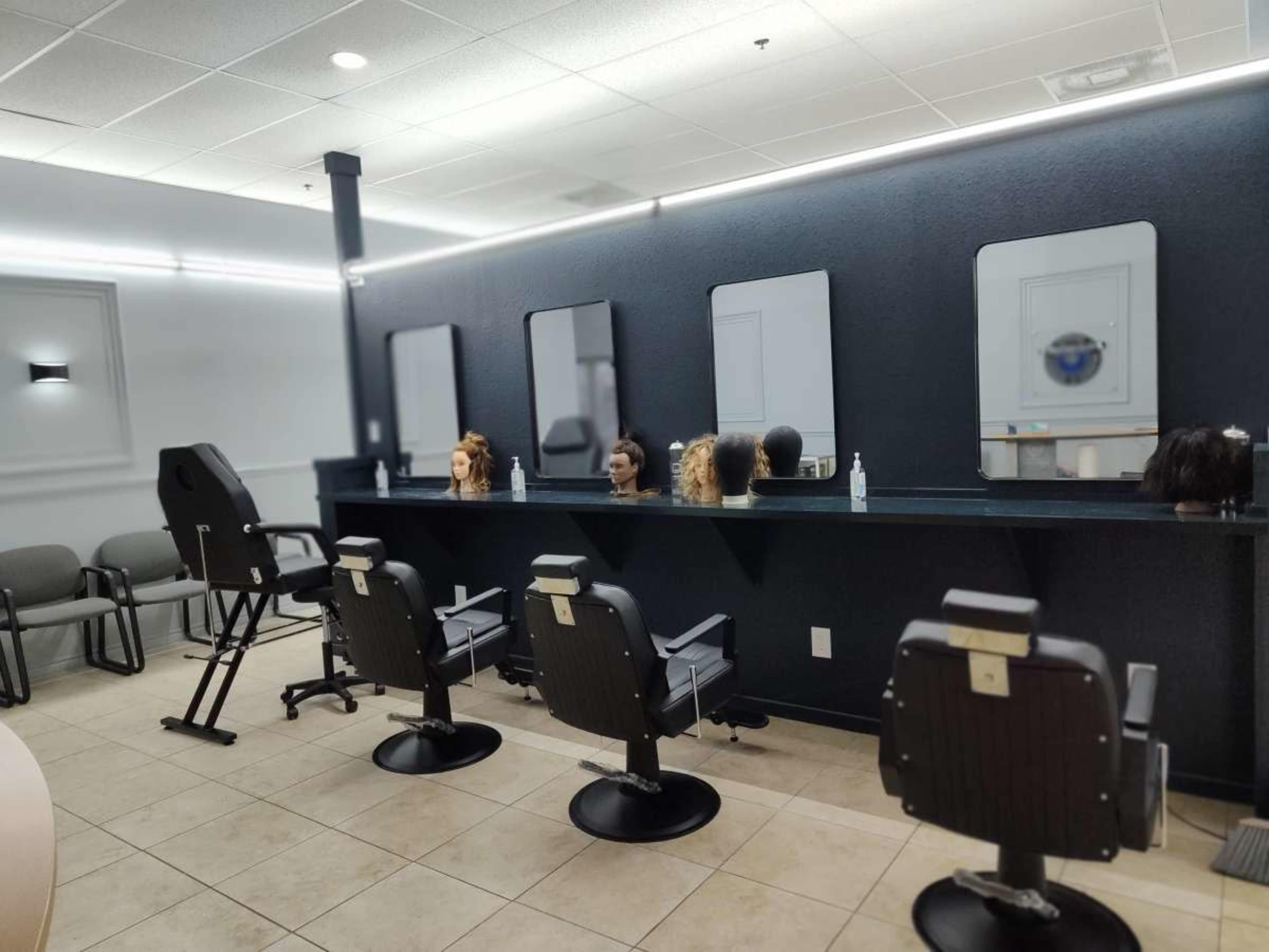 A hair styling salon with several salon chairs and mirrors along a dark wall, and mannequin heads on display.
