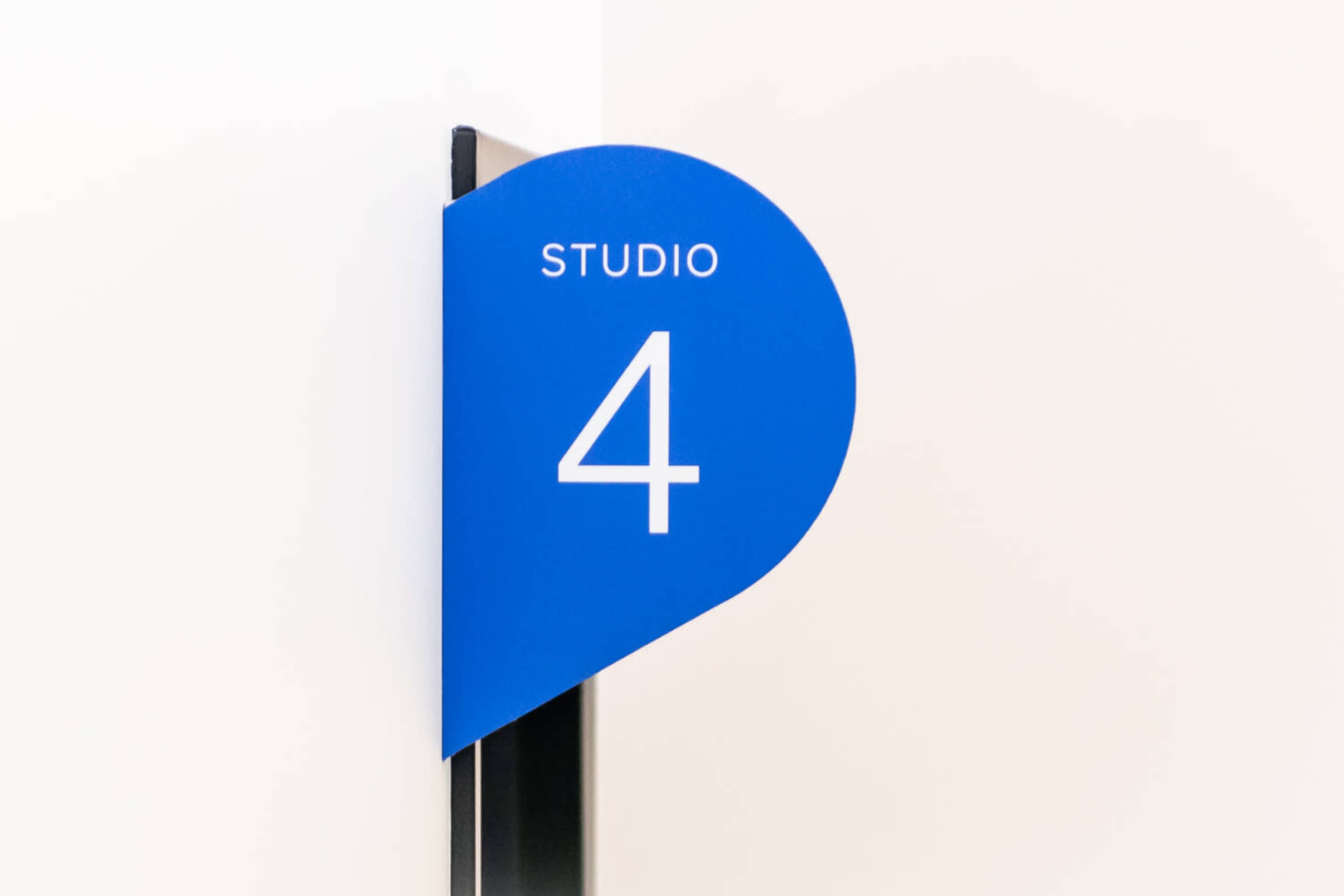 A blue sign labeled "STUDIO 4" is mounted on a wall corner.