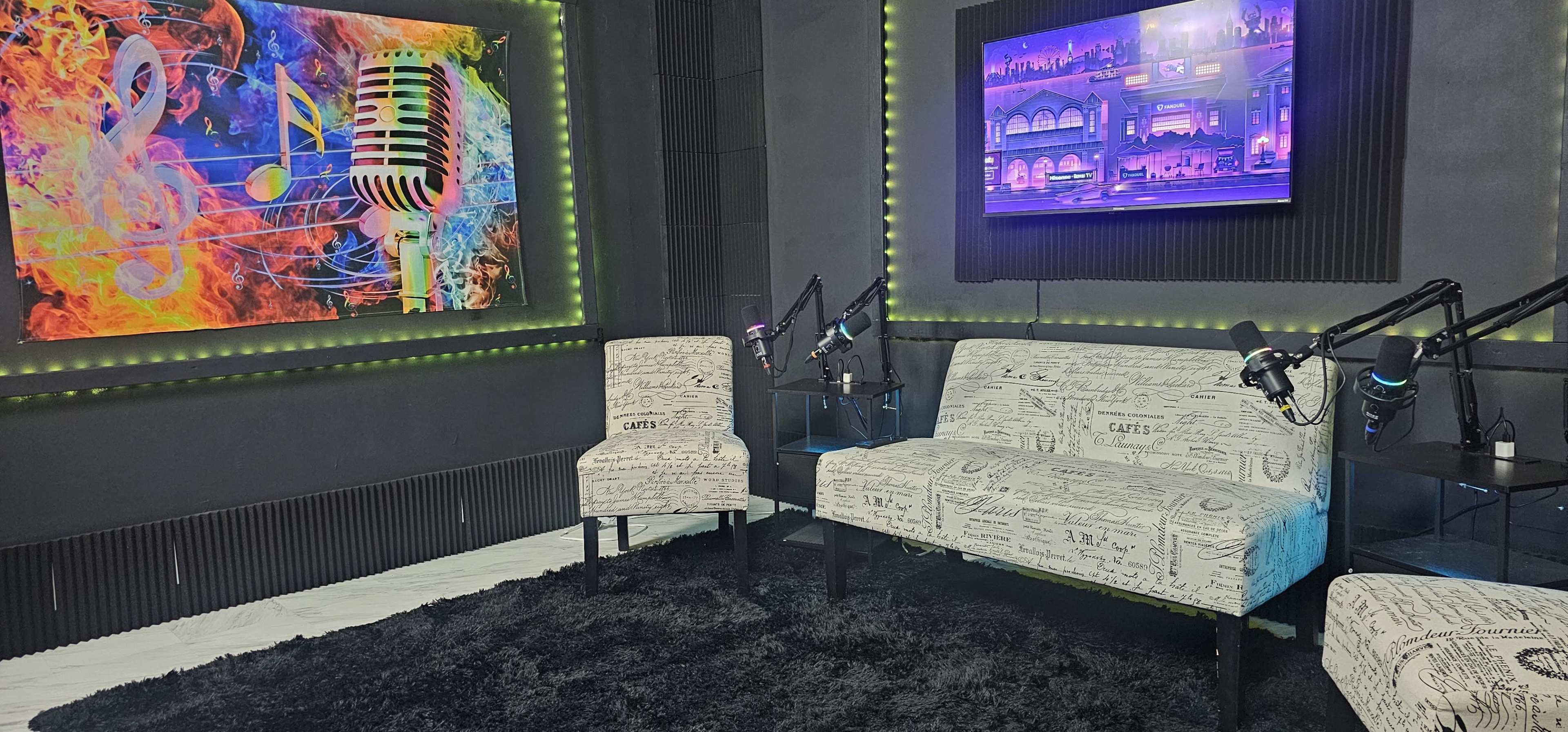 The image features a modern recording studio boasting a vibrant microphone artwork on the wall, two patterned chairs, and a large screen displaying a colorful digital scene, all illuminated with green lighting.