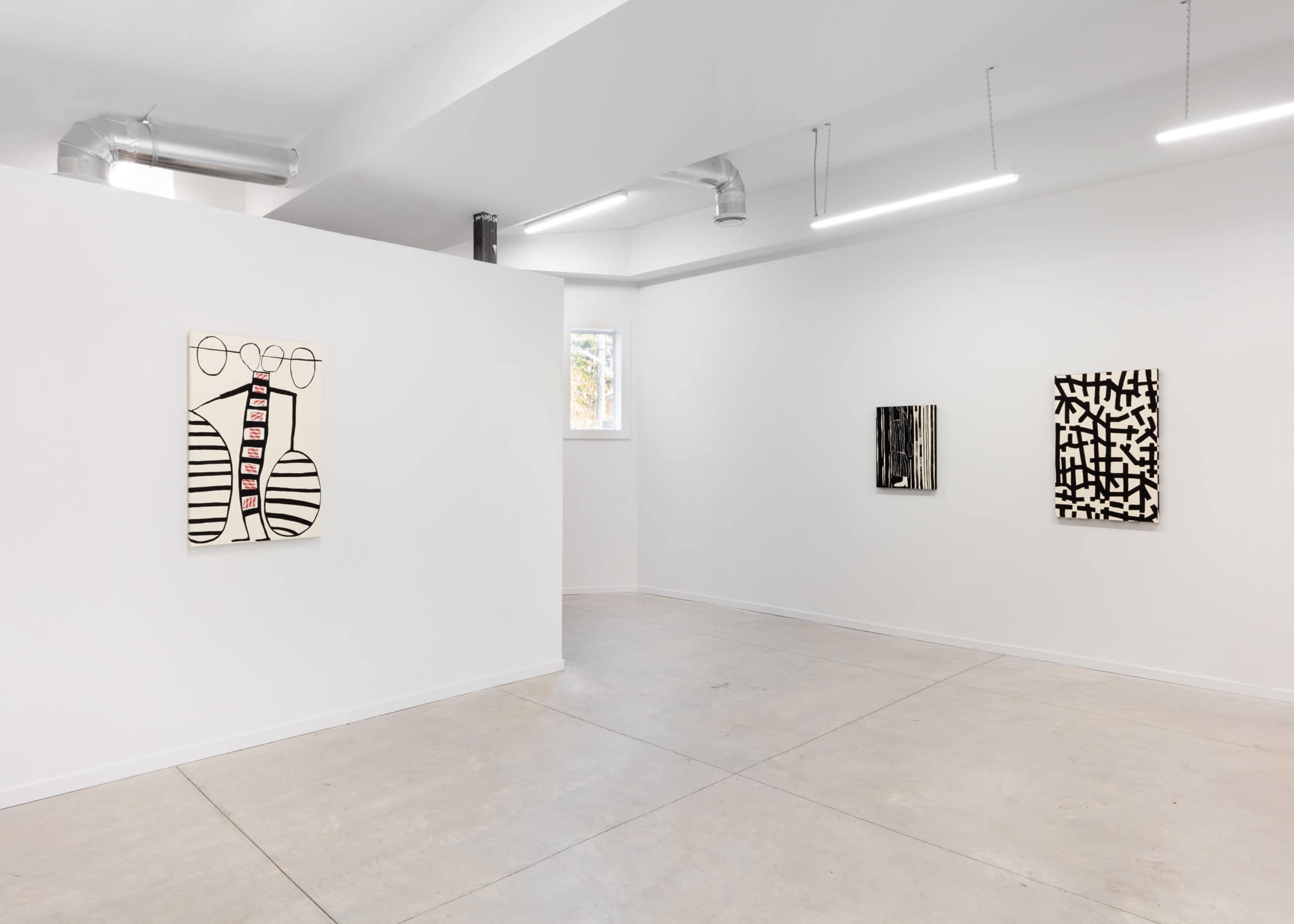 A minimalist art gallery with white walls displaying two abstract artworks.