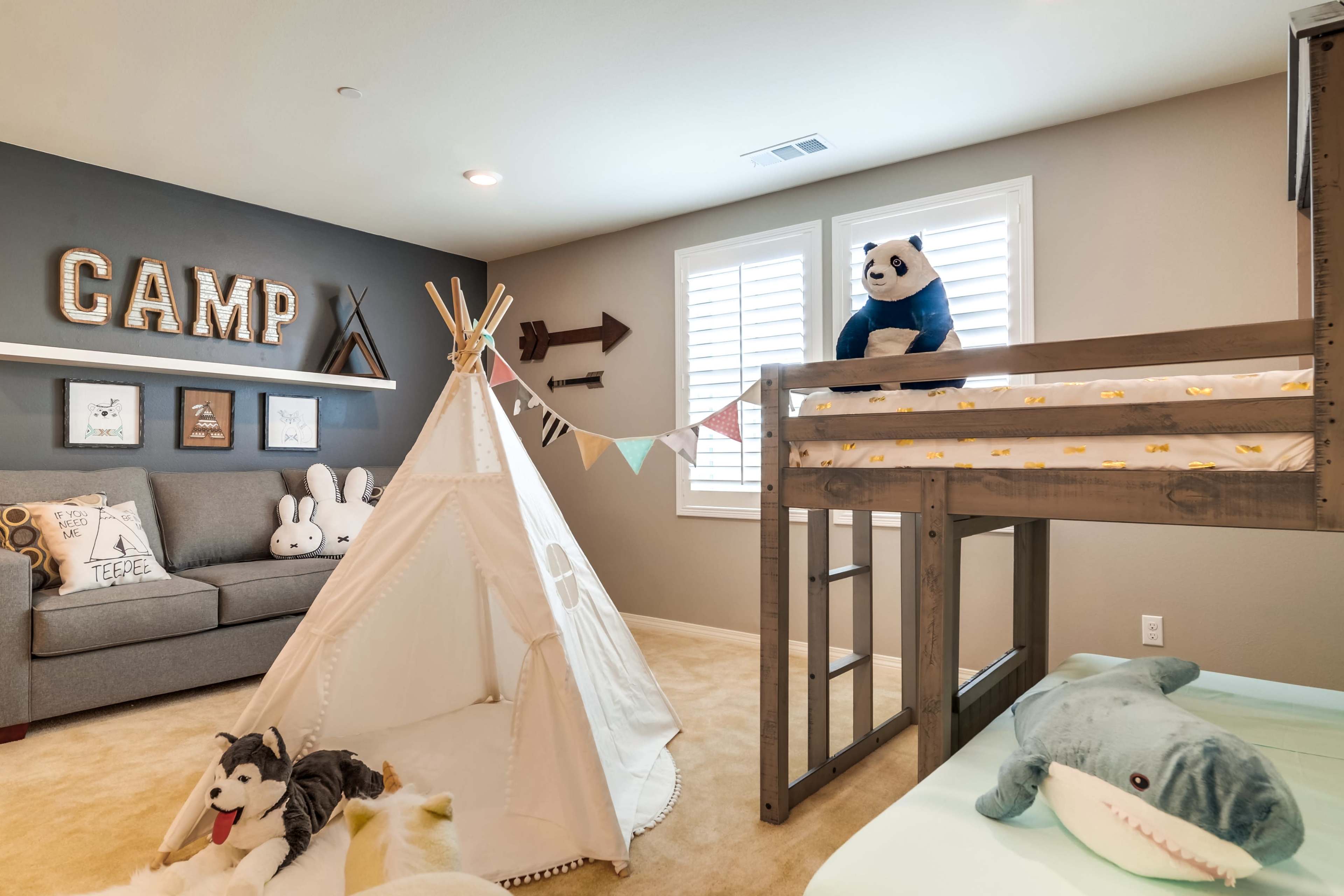 A children's bedroom features a bunk bed, a teepee play tent, stuffed animals, and decorative wall elements.