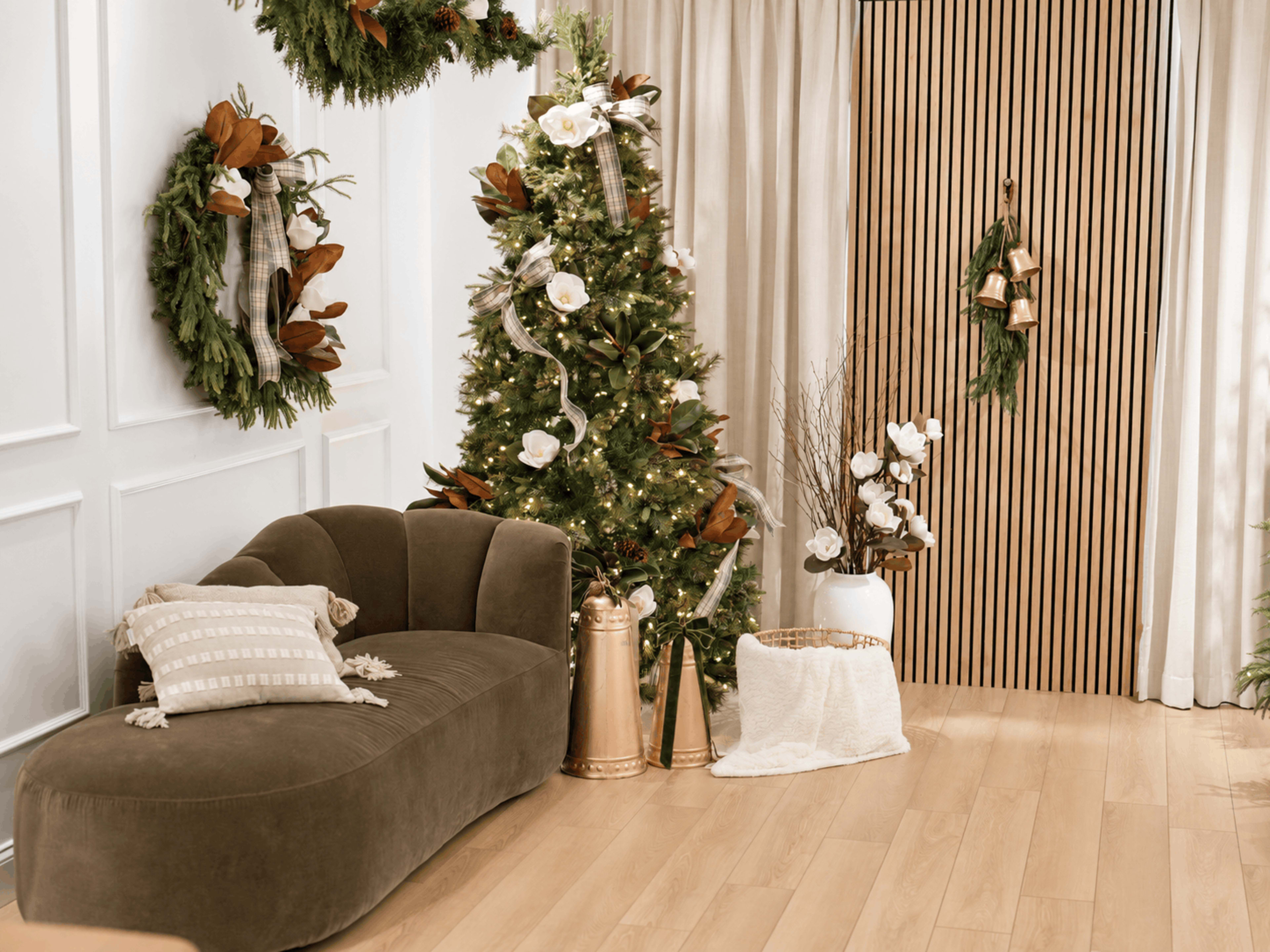 The image shows a festive living room decorated for the holidays, featuring a Christmas tree, wreaths, and a cozy sofa.