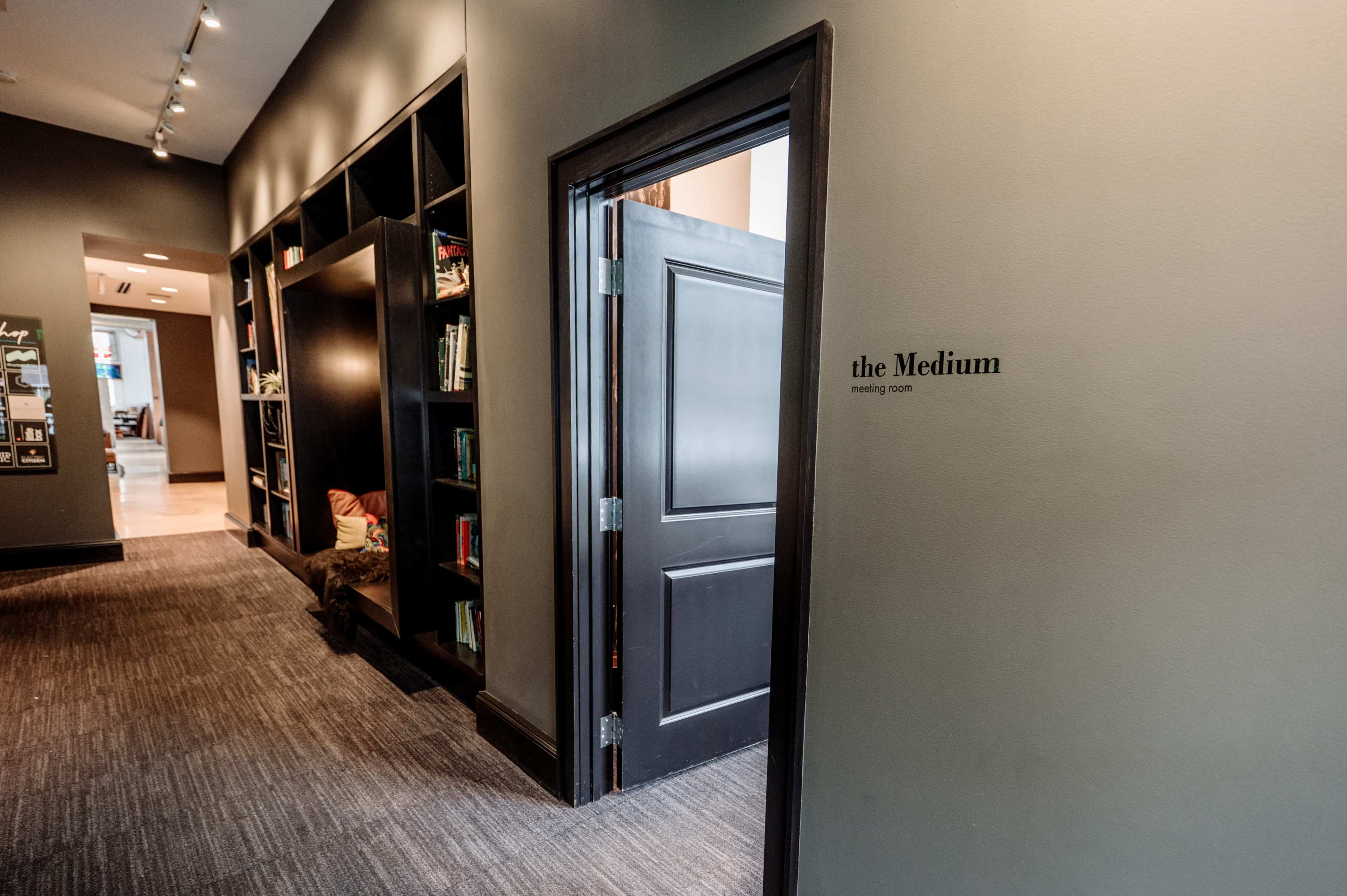 A doorway labeled "the Medium" leads into a meeting room, with bookshelves lining the adjacent wall.