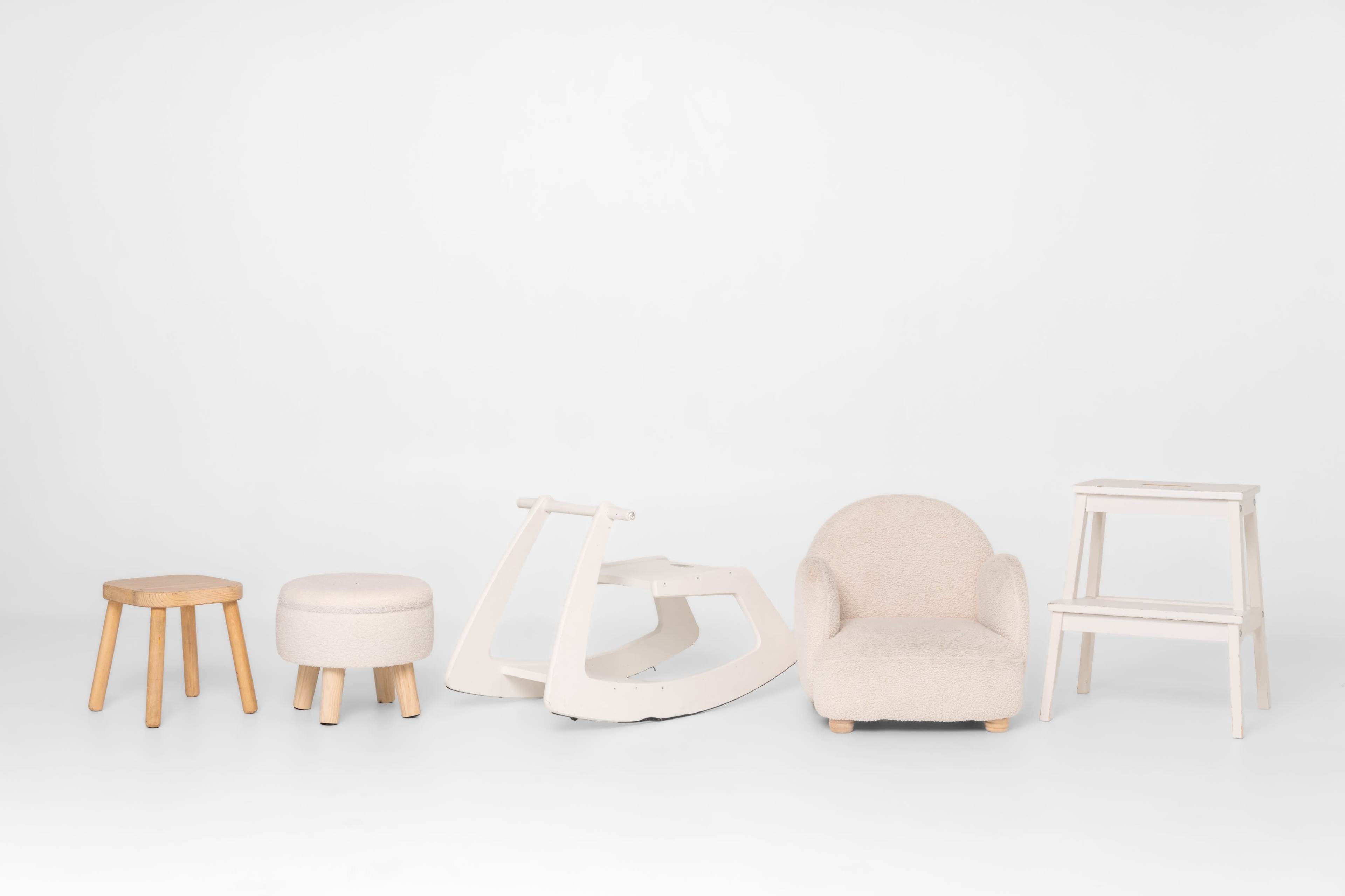 The image depicts a variety of furniture pieces, including a stool, an ottoman, a rocking chair, an armchair, and a step stool, arranged against a white background.