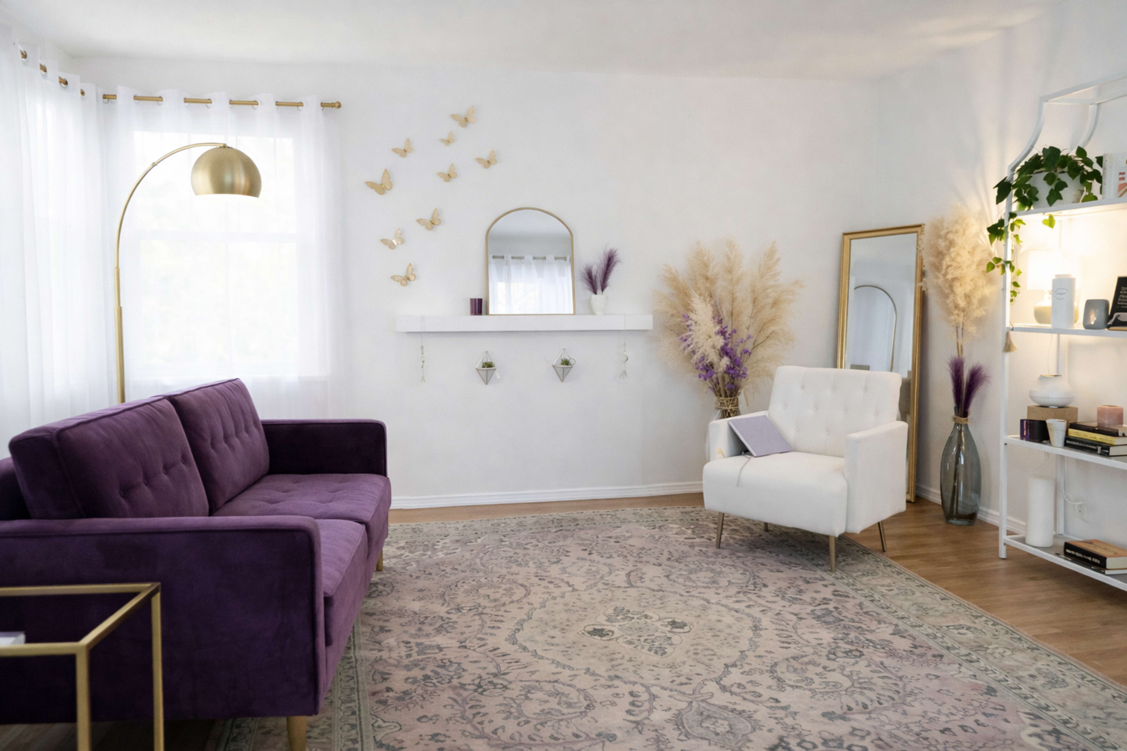 A modern living room features a purple sofa, a white armchair, and decorative plants against a light-colored wall.