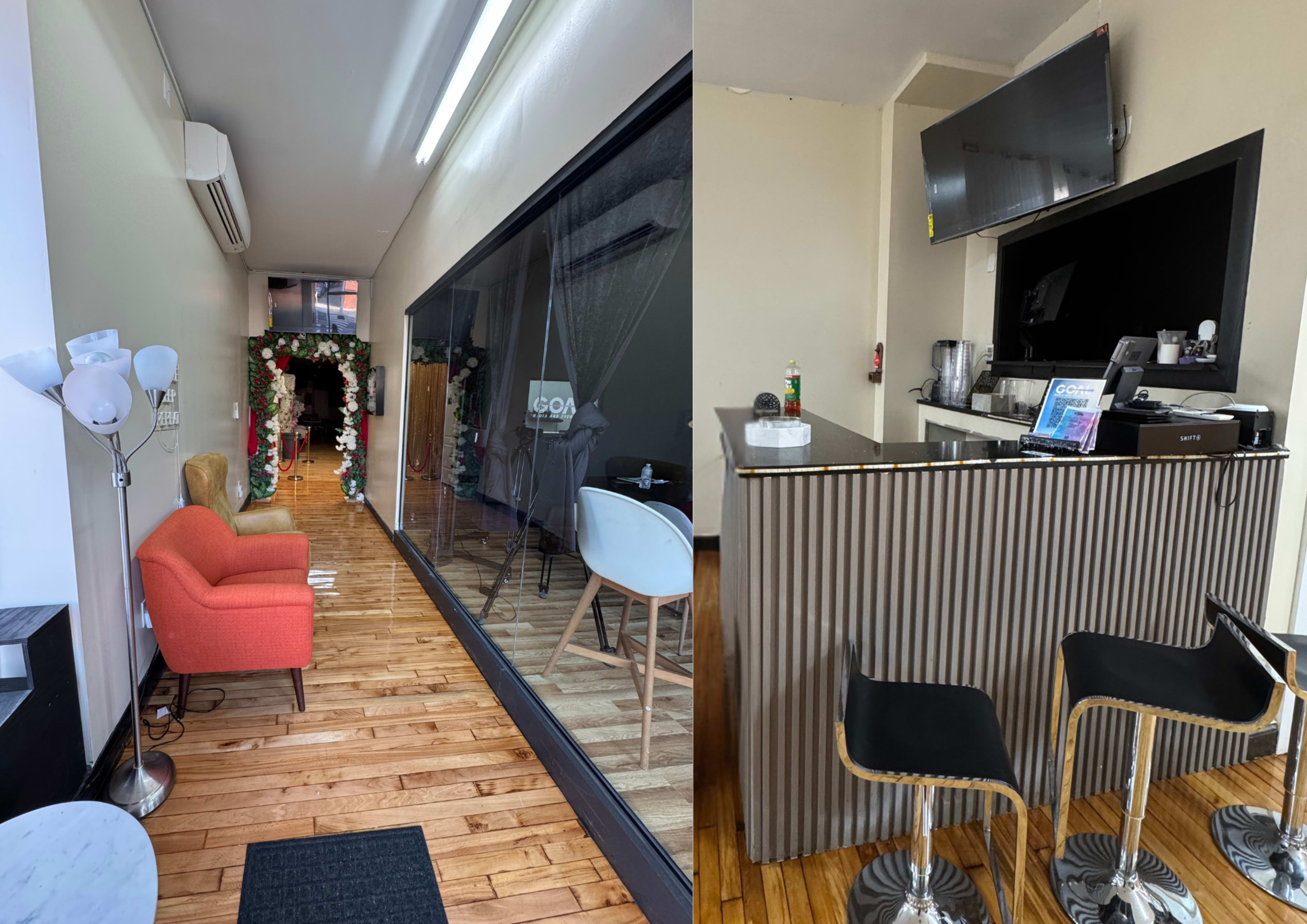 The image shows a modern interior space with a reception area featuring a lounge chair, and a bar counter with high stools in a brightly lit room.