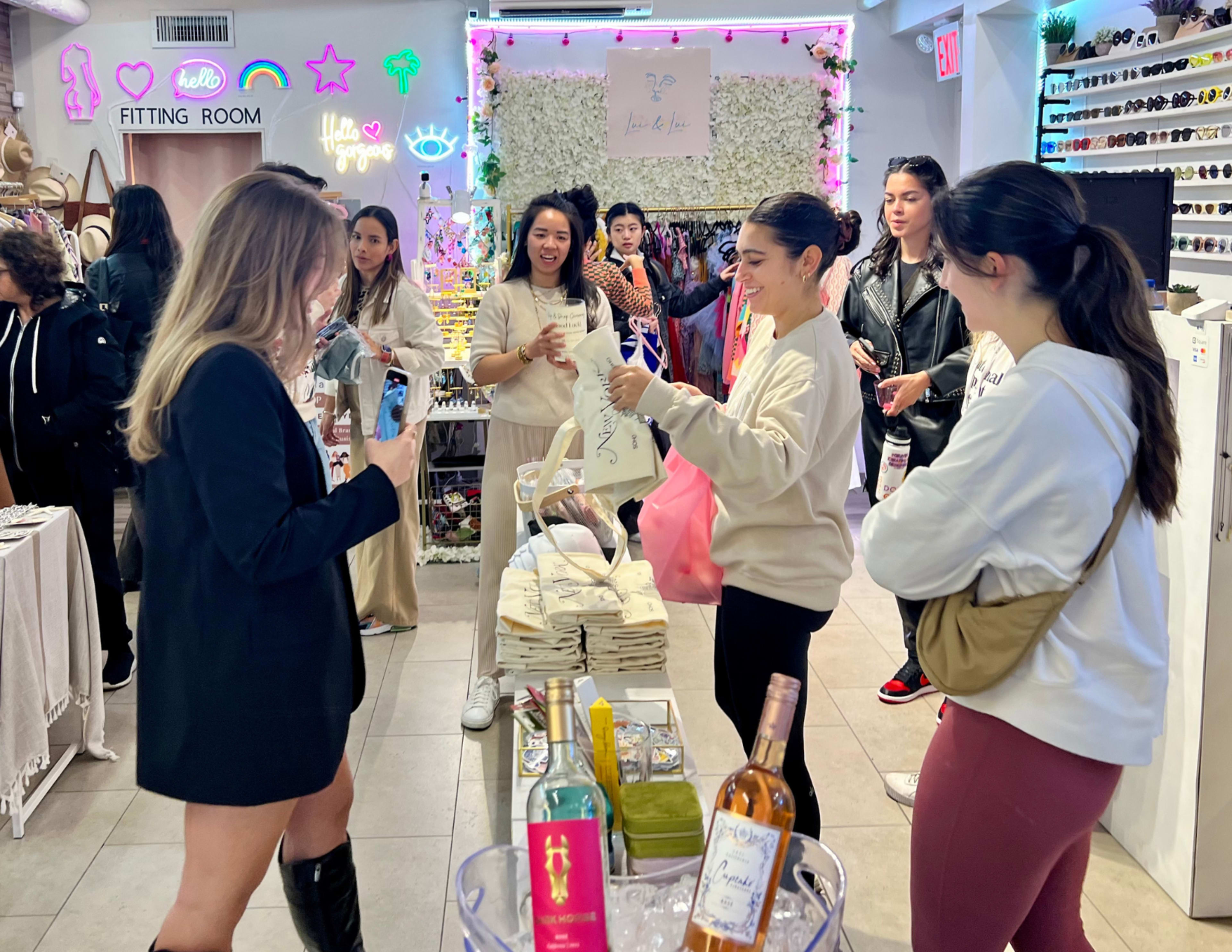 A group of women are shopping and interacting while browsing products in a brightly lit retail space.