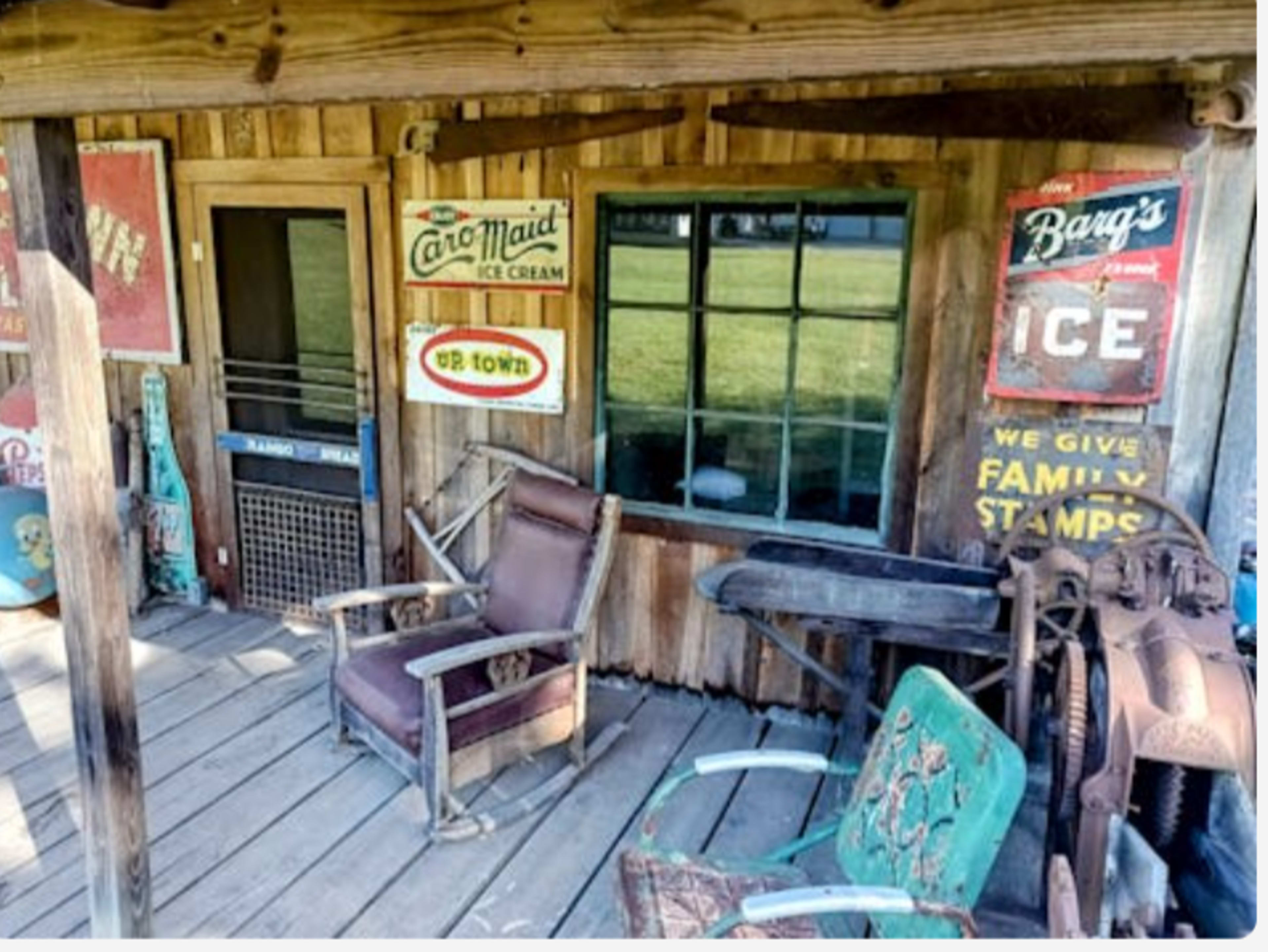 The image displays a rustic wooden porch with vintage signs and an old-fashioned ice cream shop facade.
