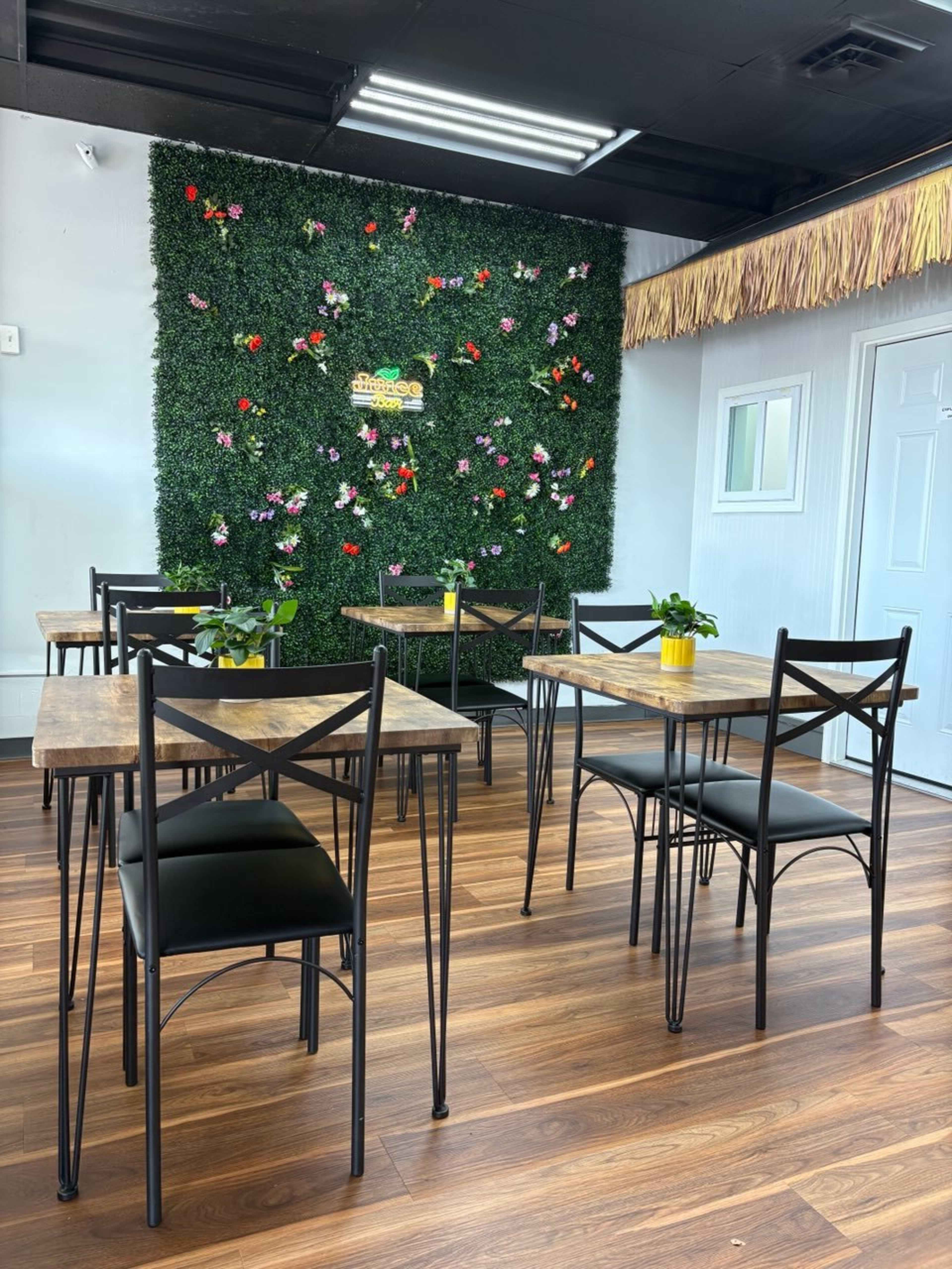 Open-Concept Juice Bar with Wood Bar, Greenery Wall & Café Seating Image in College Park, College Park, GA