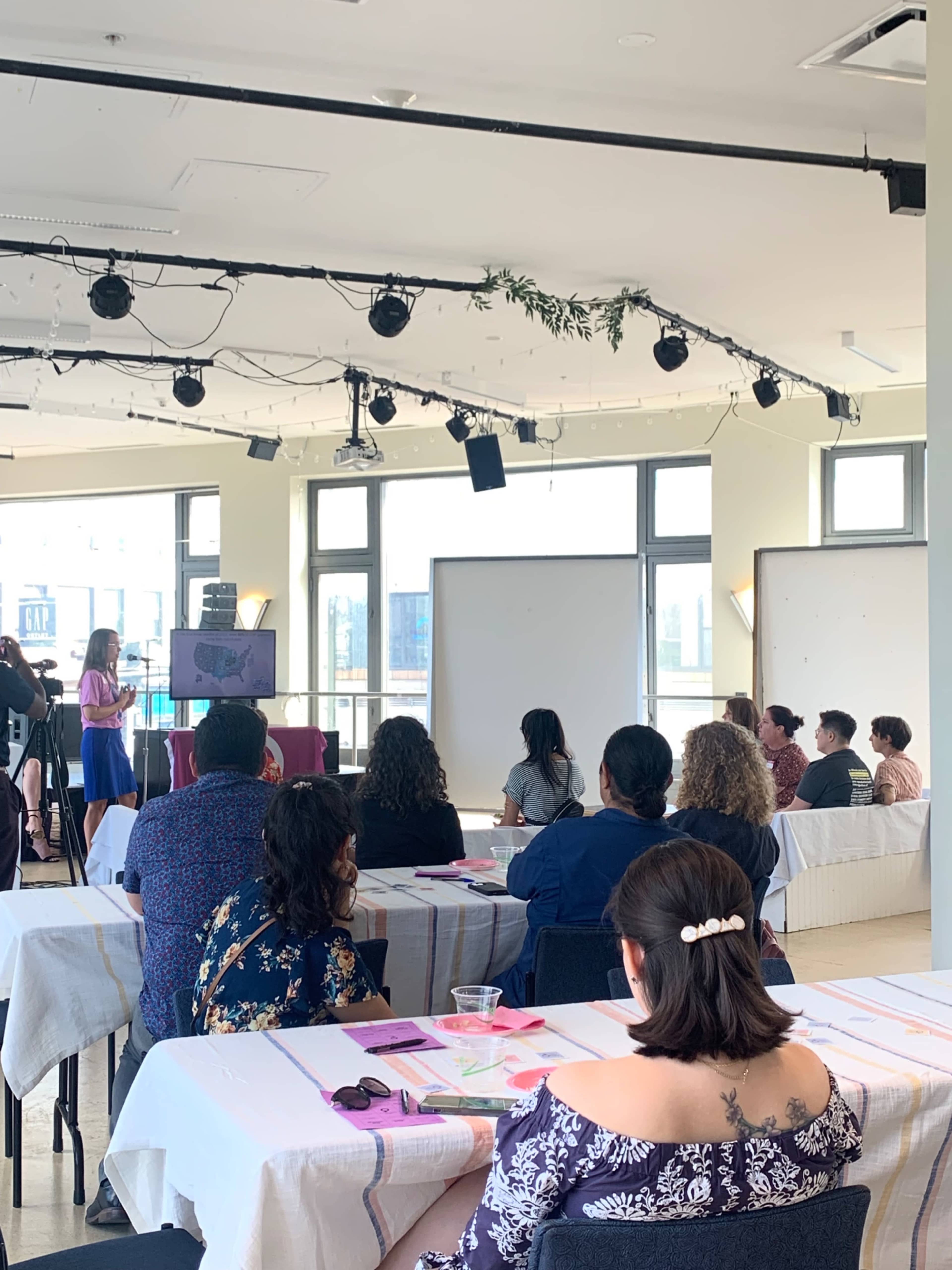 Large open floor plan with floor to ceiling windows over looking urban street scape. Image in Avondale, Chicago, IL