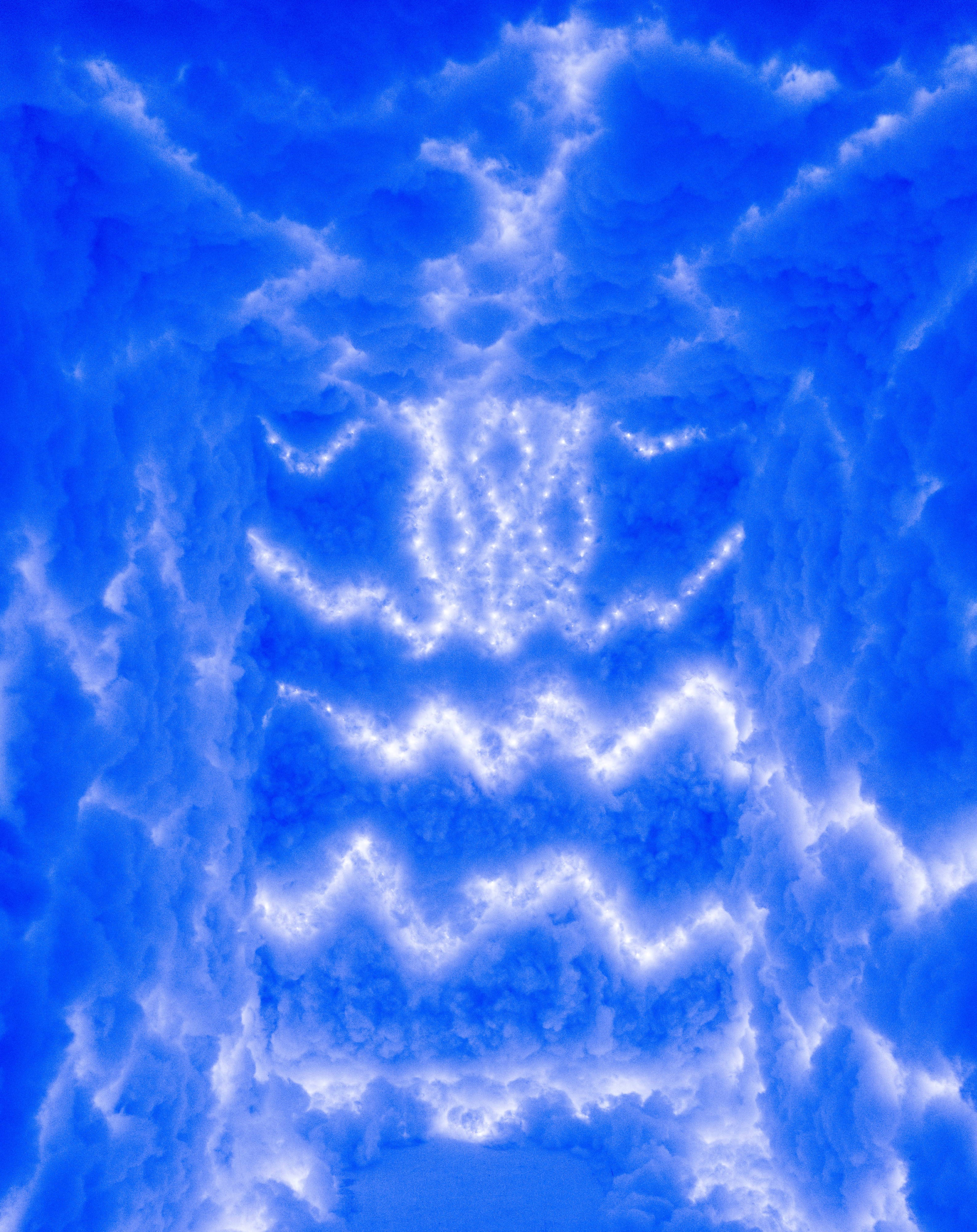The image depicts a vibrant blue sky filled with fluffy white clouds illuminated by bright light.