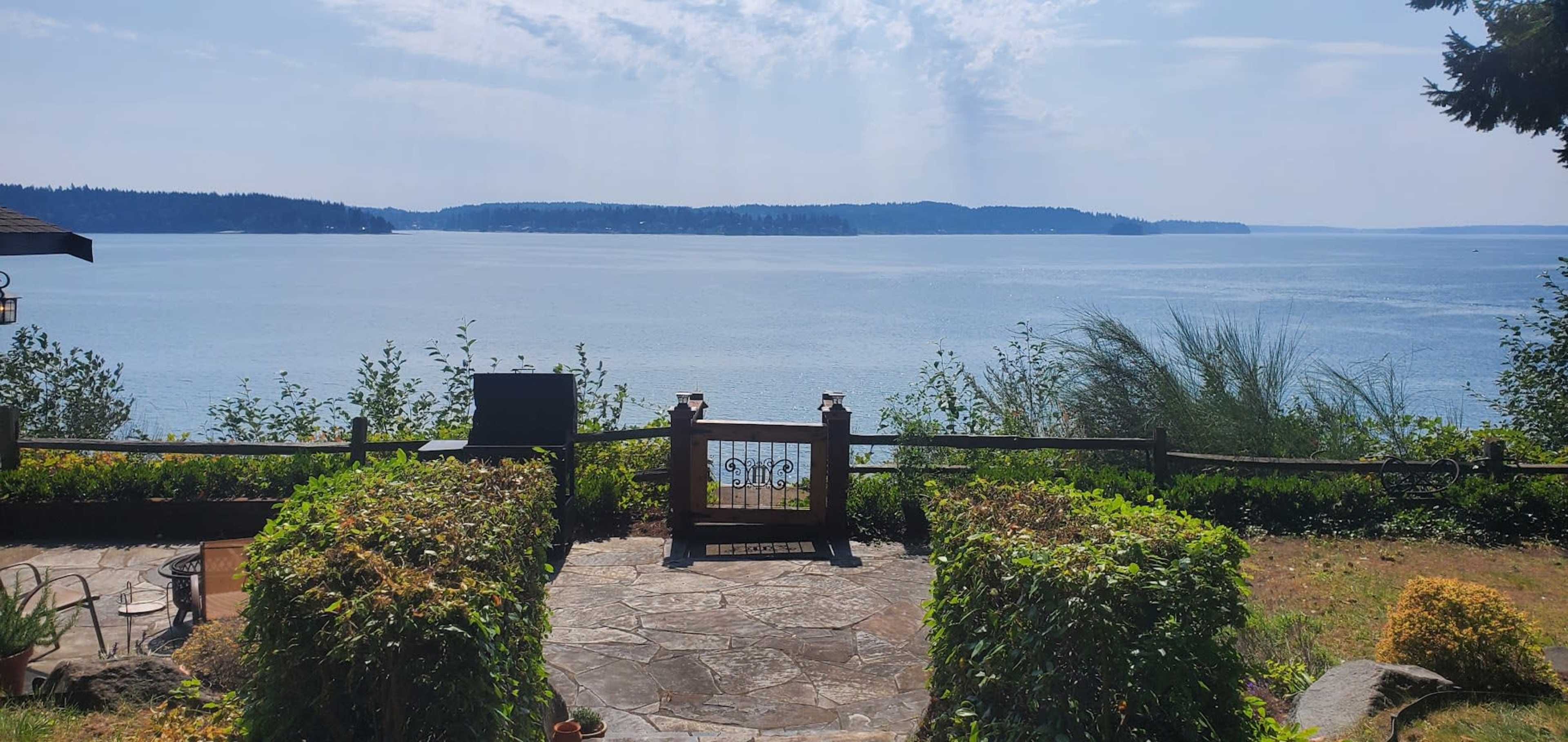 Cute Wide Waterfront Garden Patio Looking Towards Distant Mt. Rainier Image in Wauna, Gig Harbor, WA
