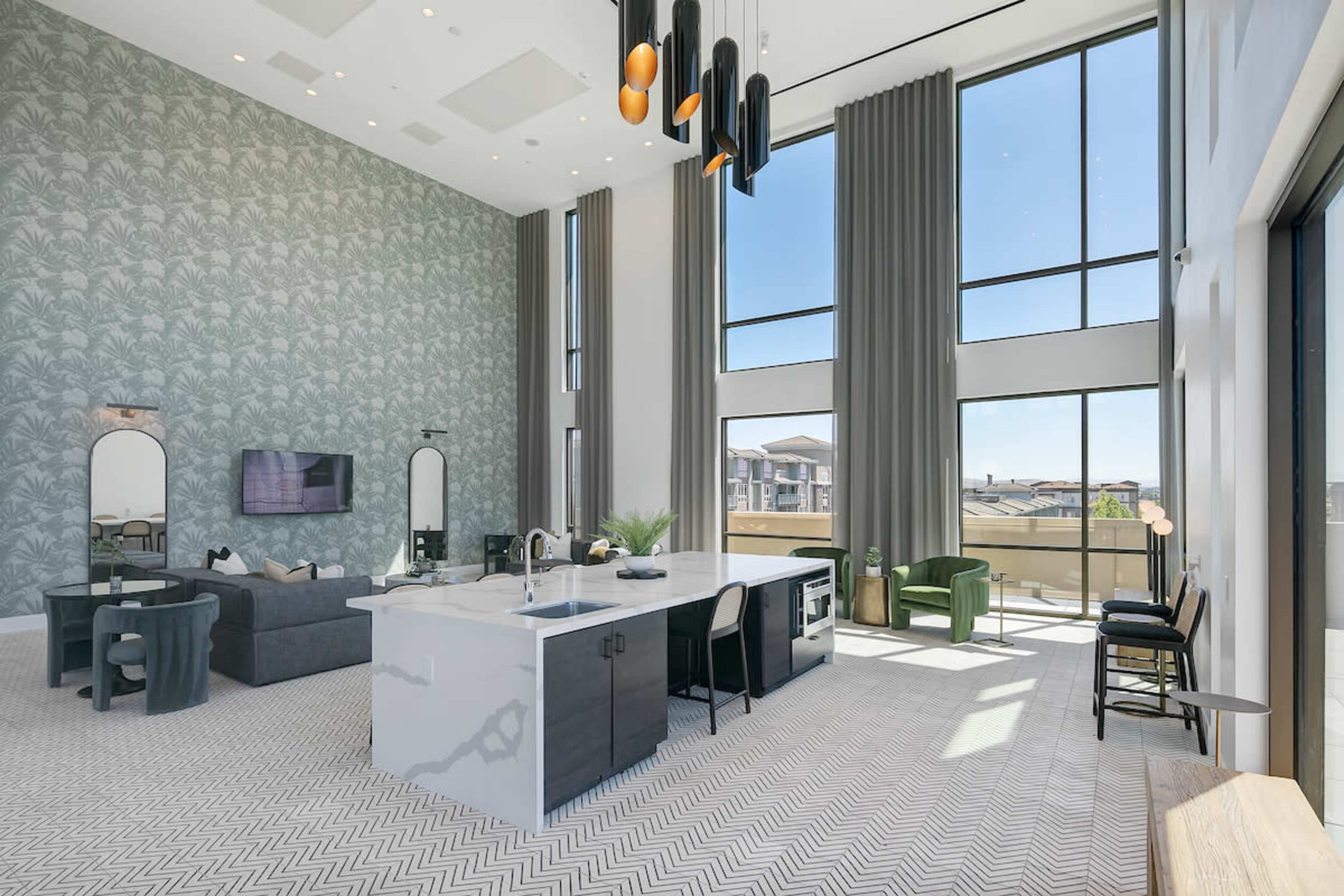 A modern open-concept living space features large windows, a kitchen island, and stylish furnishings against a patterned wallpaper backdrop.