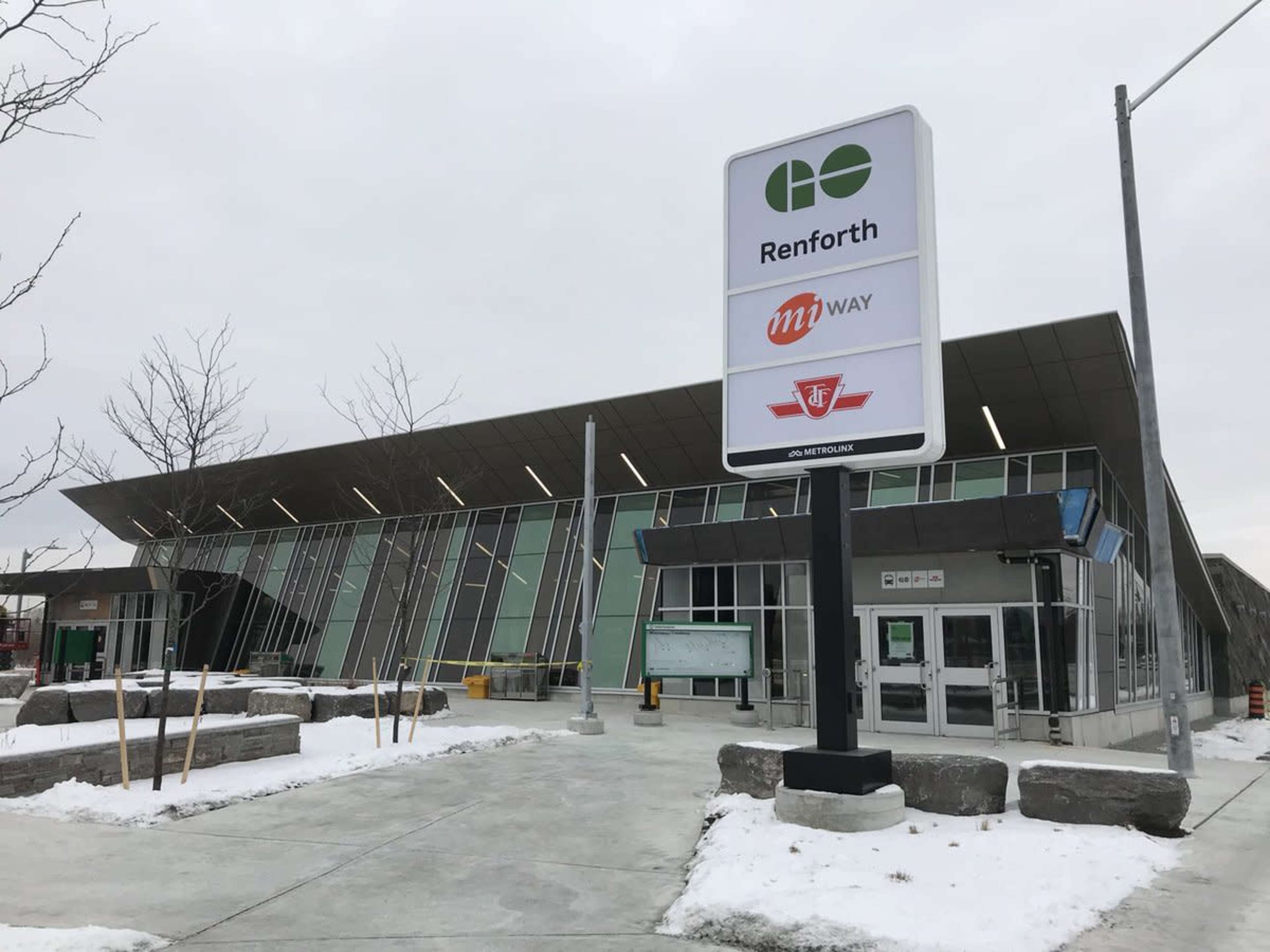 The modern exterior of the Renforth transit terminal, featuring large glass panels and signage for MiWay and the Toronto Transit Commission (TTC).
