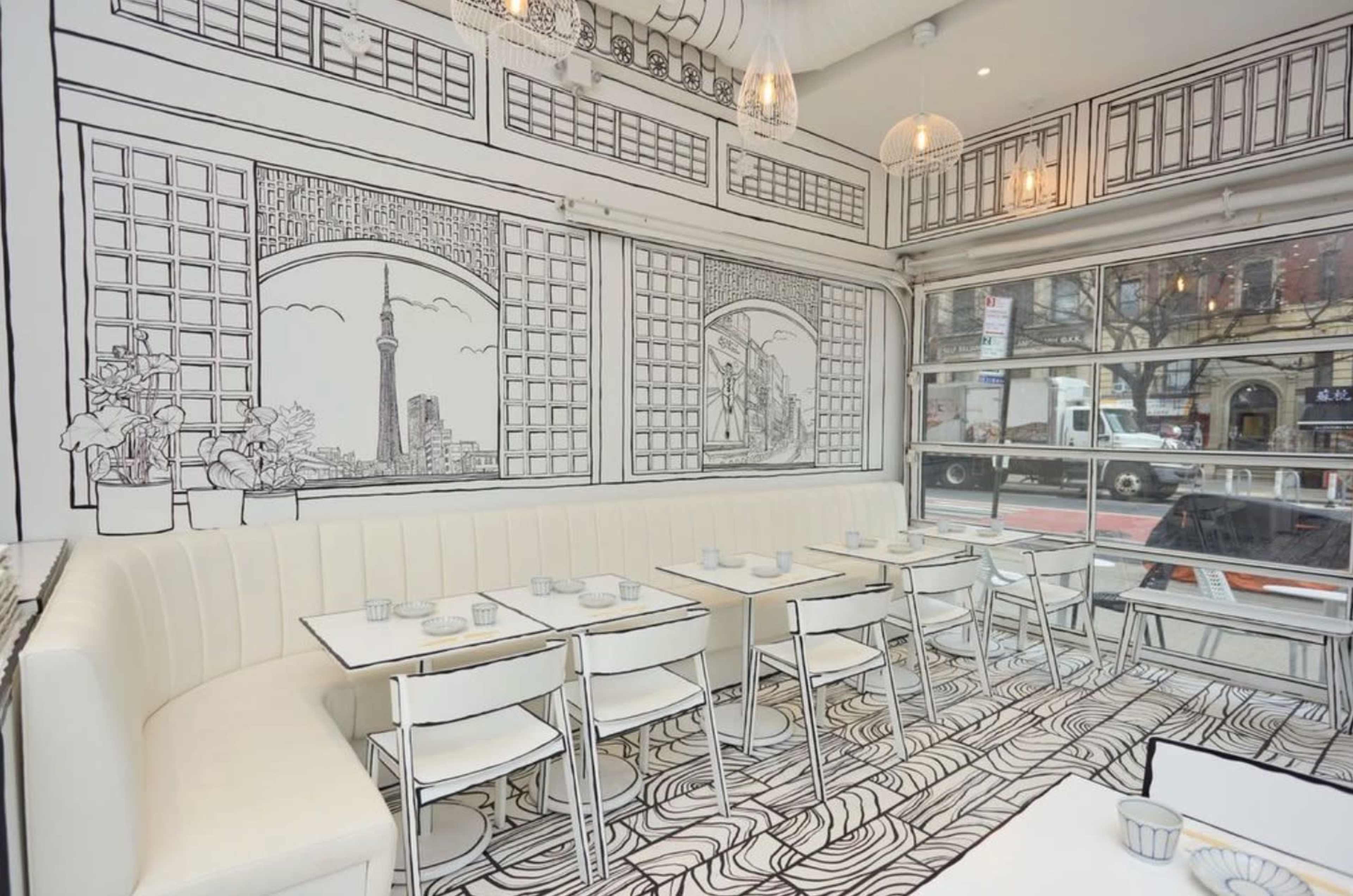 The image shows a modern restaurant interior with white furniture and black line-drawn illustrations on the walls and floor depicting a cityscape.