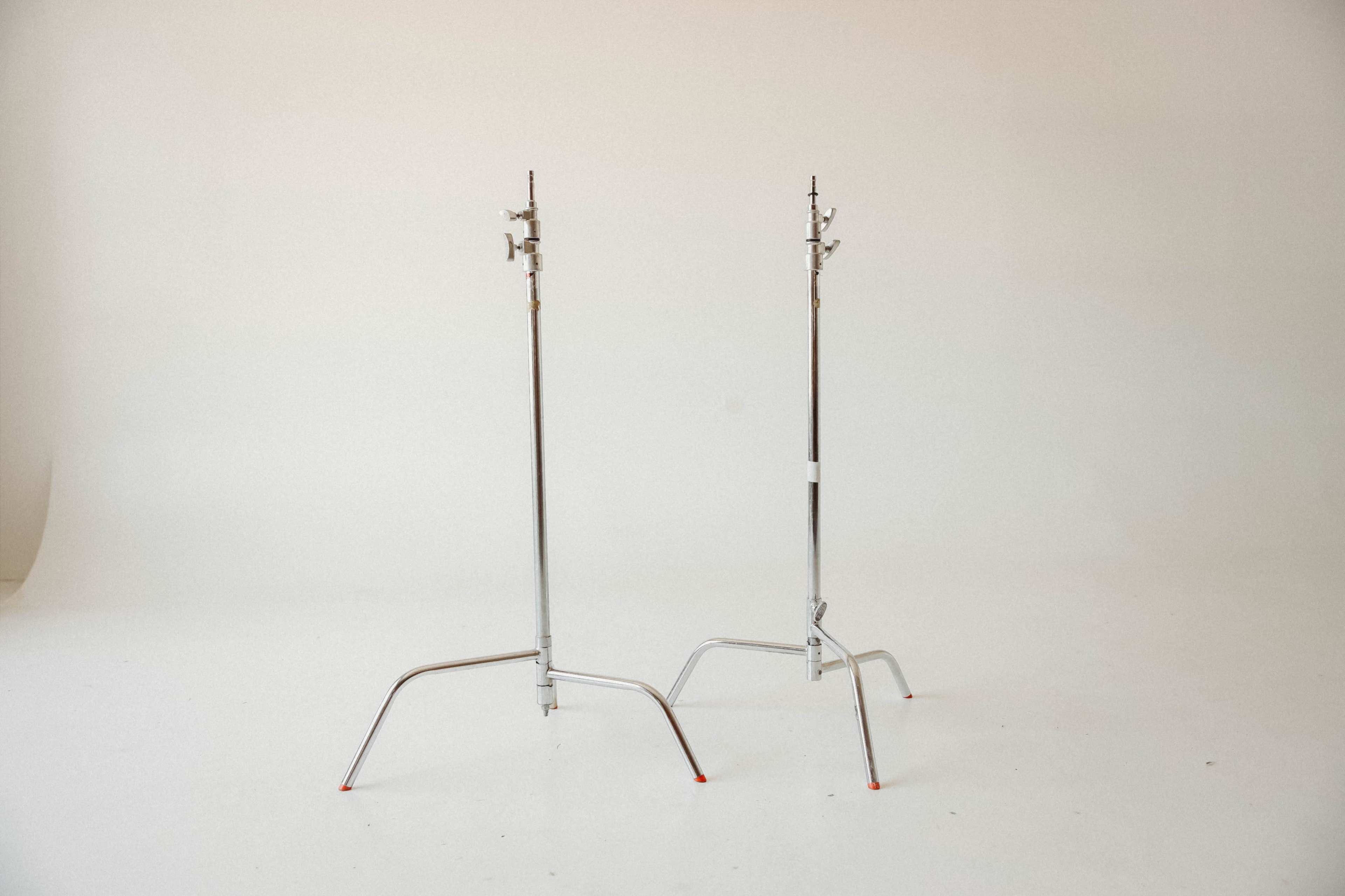 Two chrome light stands are positioned on a white backdrop.