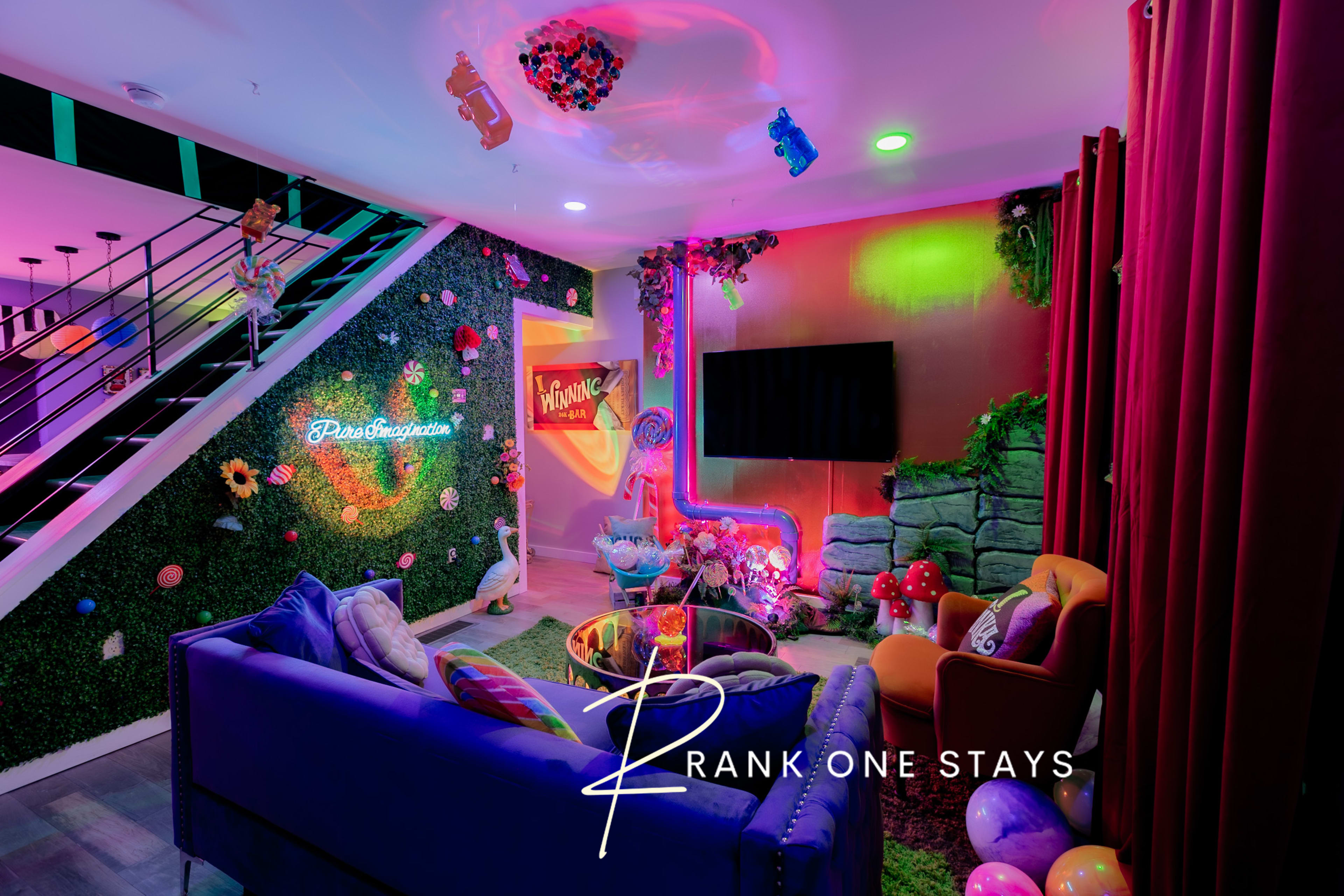 A brightly colored living room with decorative plants, a large television, and playful furniture, illuminated by various lights.