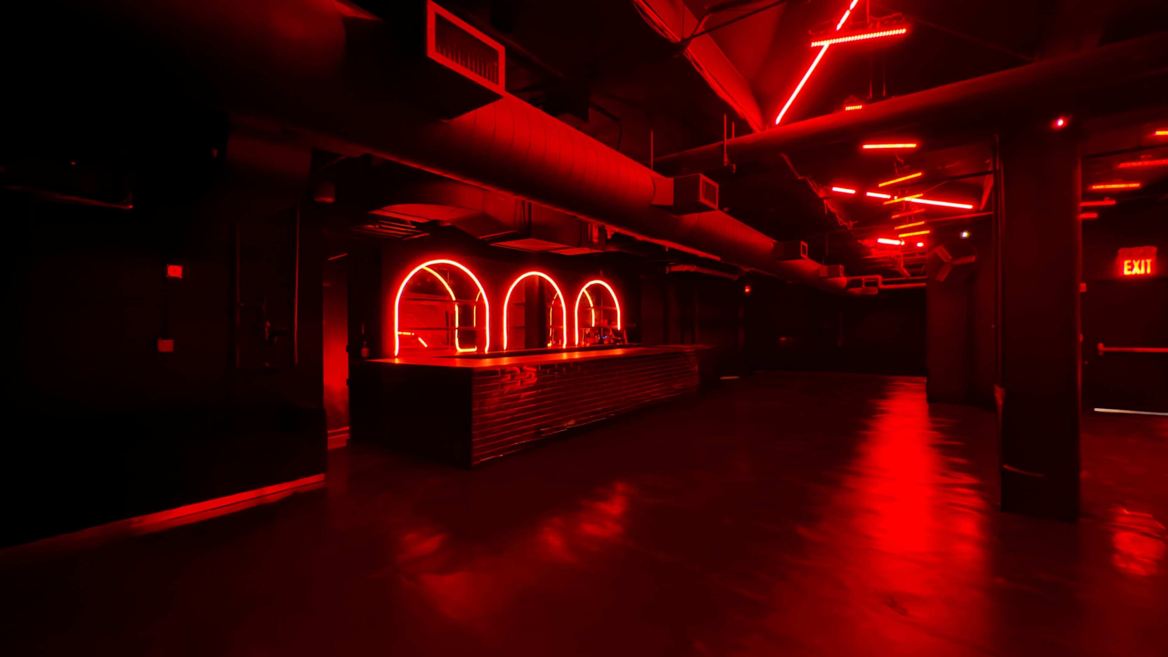 The image shows a dimly lit bar area with red neon lights and a sleek counter in an industrial-style interior.