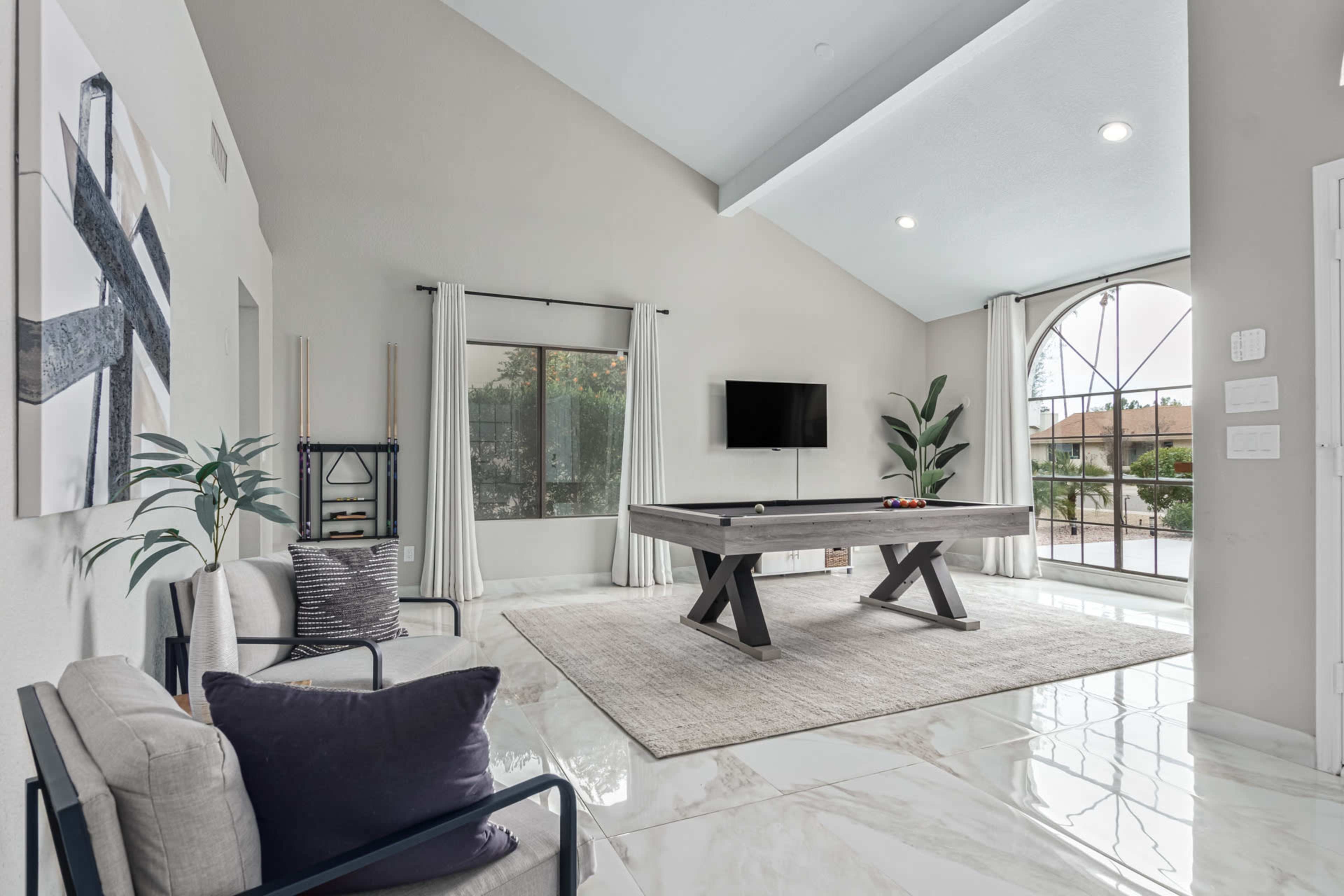 A bright living room with a large window, a modern coffee table, and minimalist furniture.