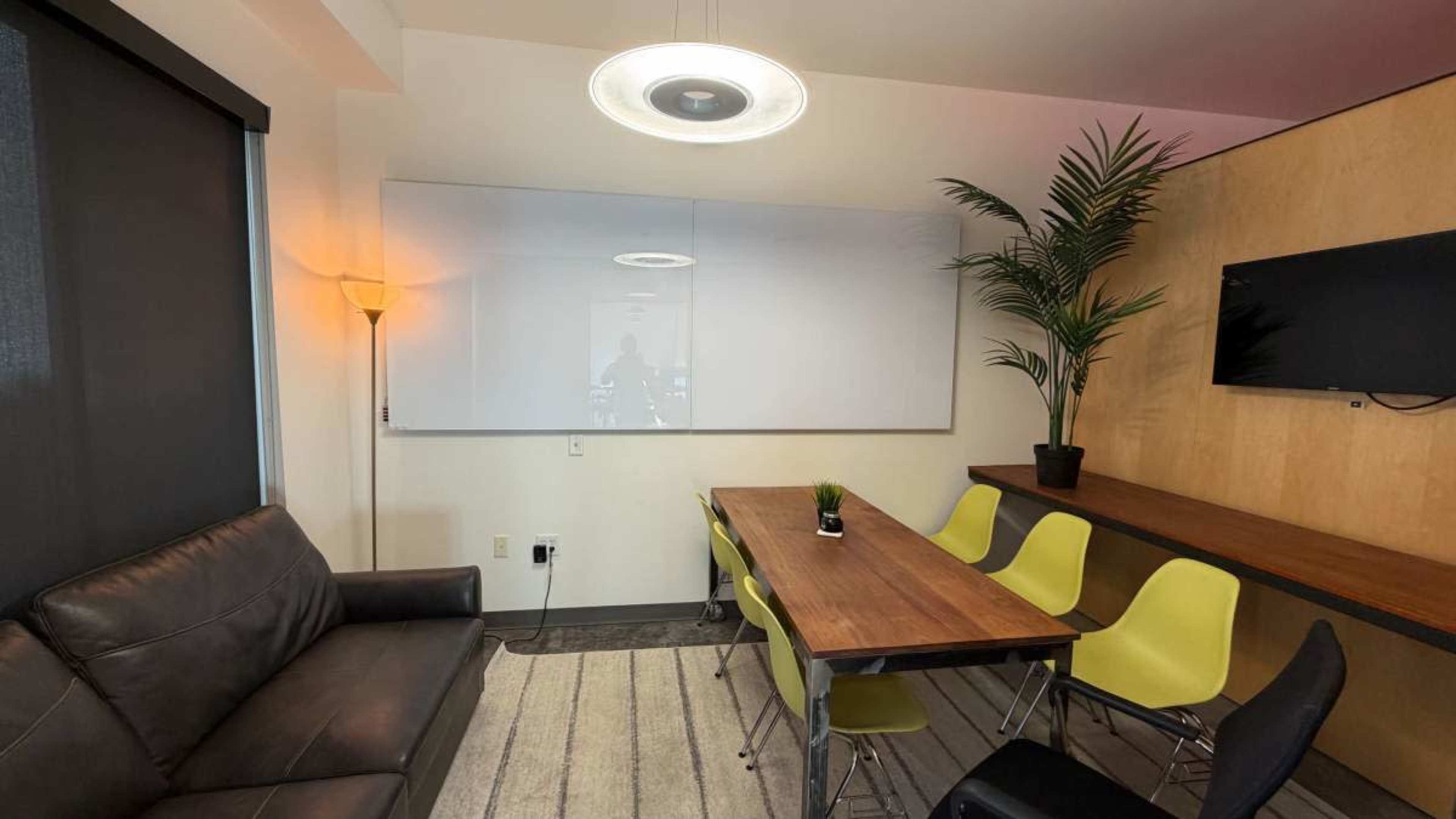 Modern Conference & Creative Meeting Room w/ Huge Glass Whiteboard, TV, & Couch Seating Image in Ballpark, Salt Lake City, UT