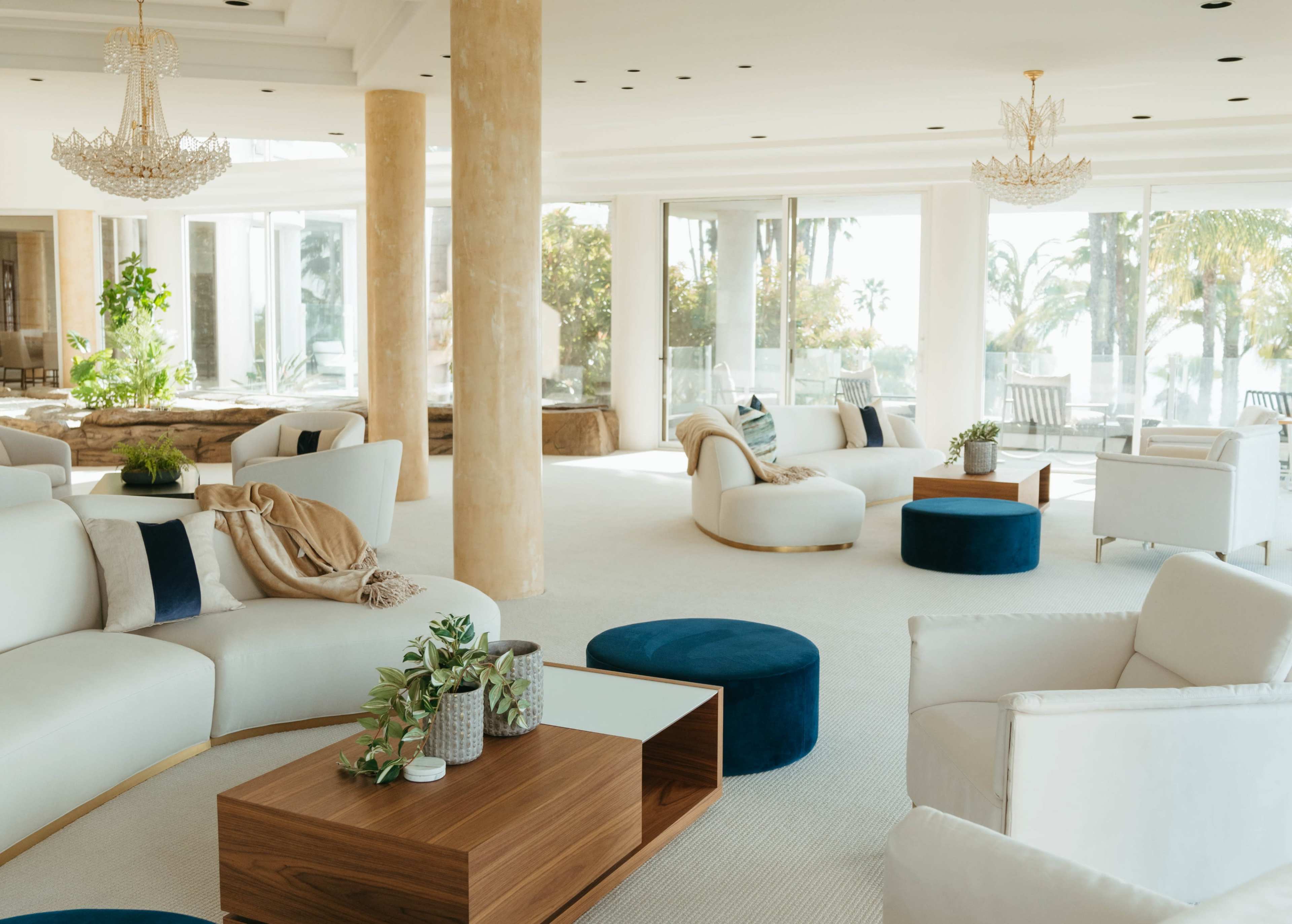 The spacious living area features plush seating, modern decor, and large windows that allow for ample natural light.