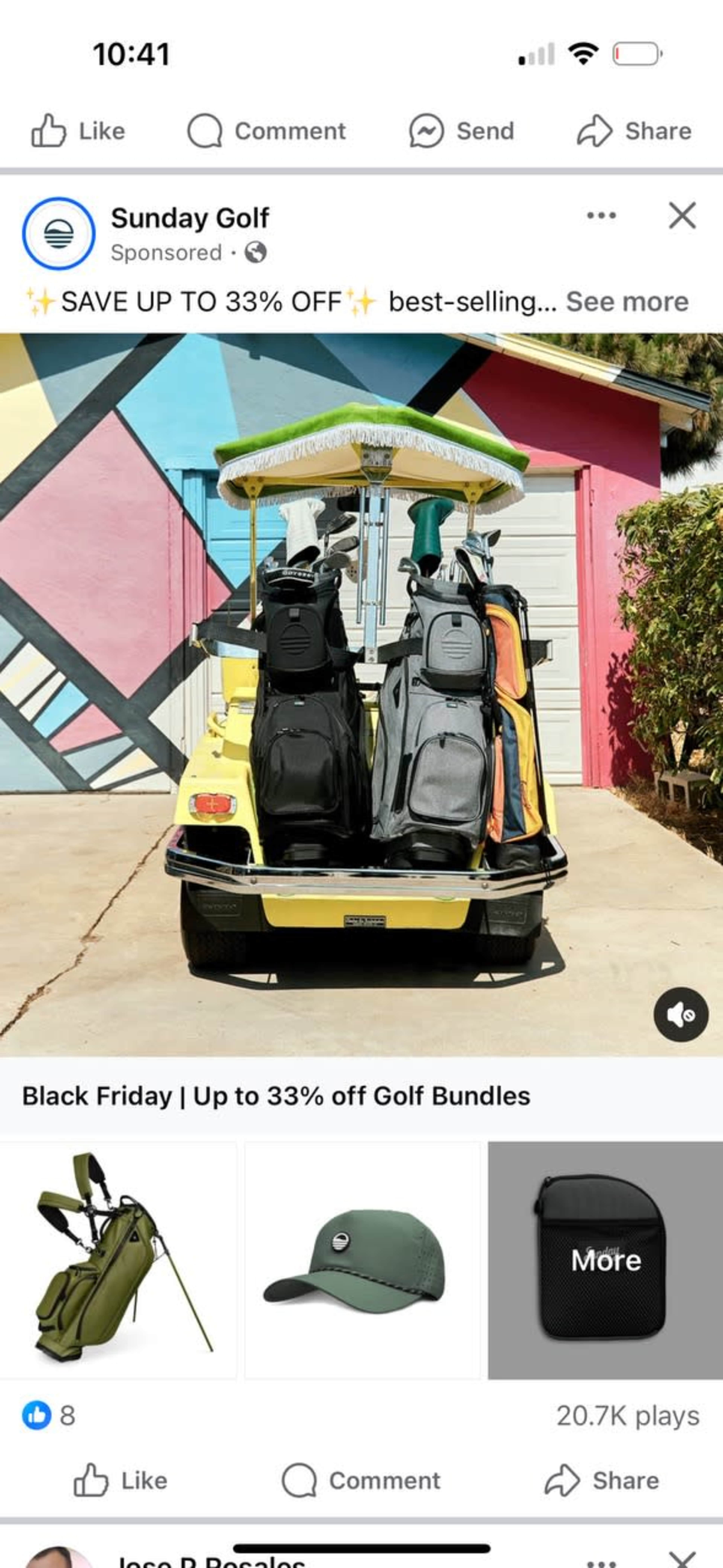 A yellow golf cart is parked in front of a colorful mural, loaded with multiple golf bags and a green umbrella.