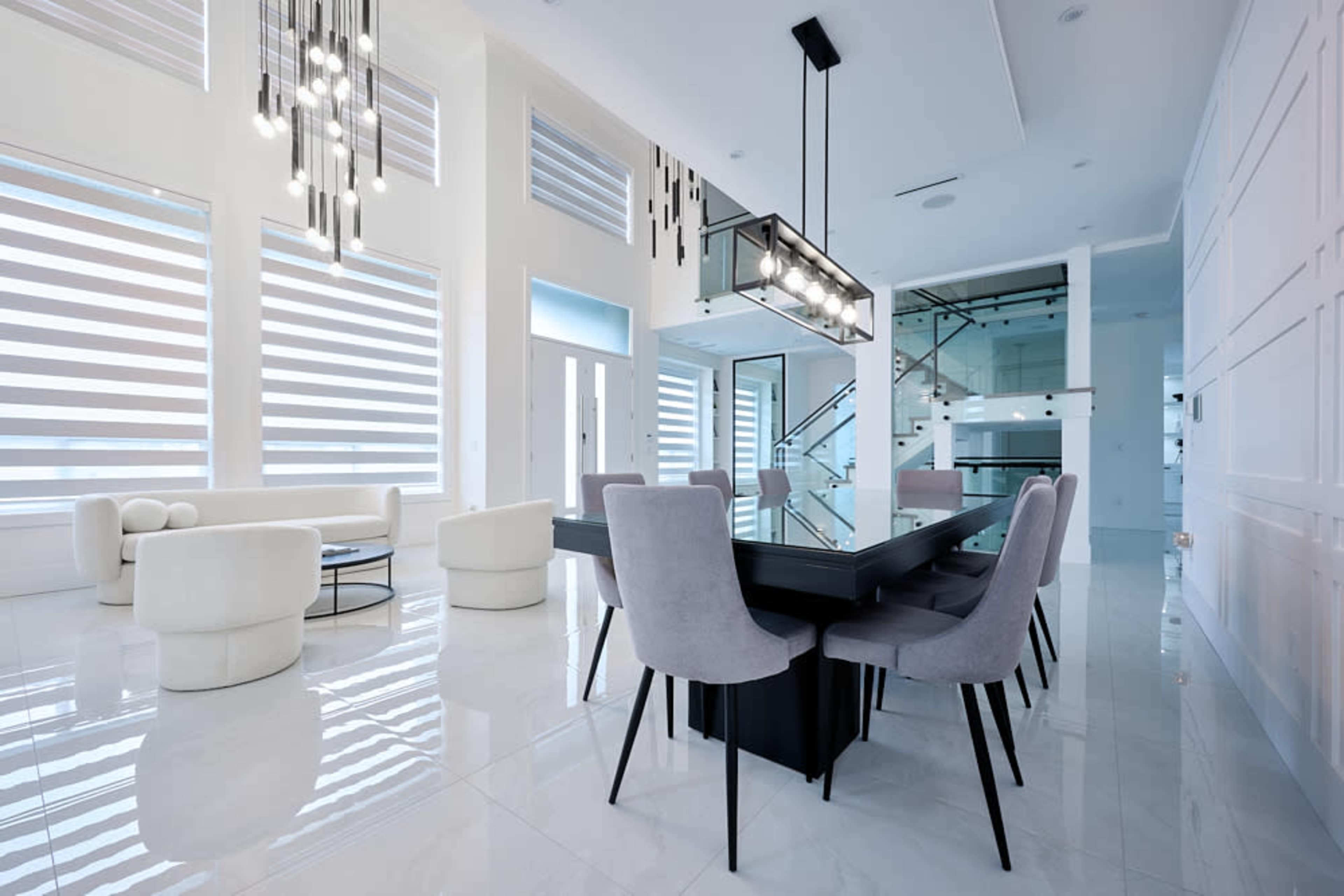 A modern dining area with sleek furniture, large windows, and a spacious, well-lit interior.