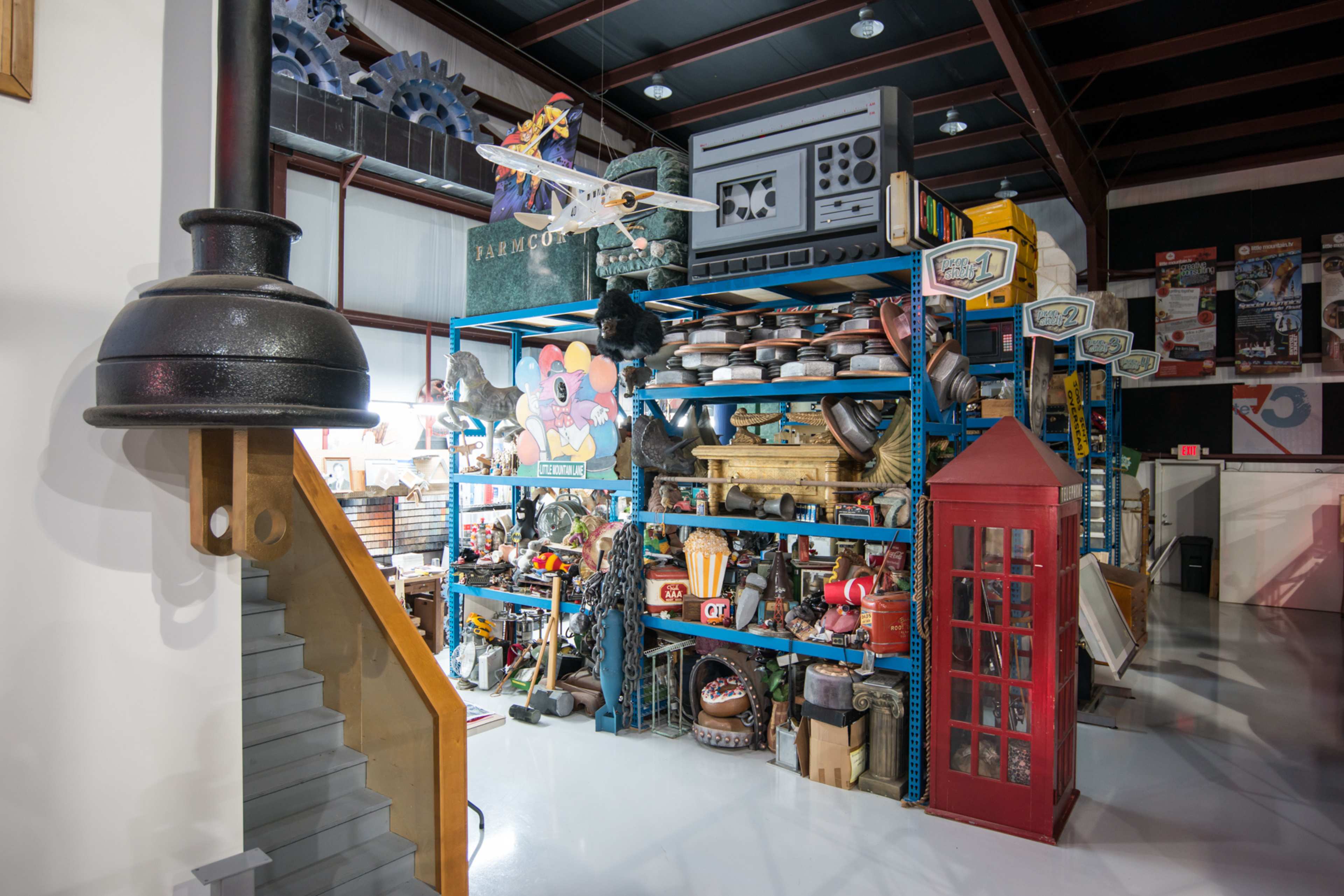 A large shelving unit filled with various vintage items and collectibles stands in a well-lit space.