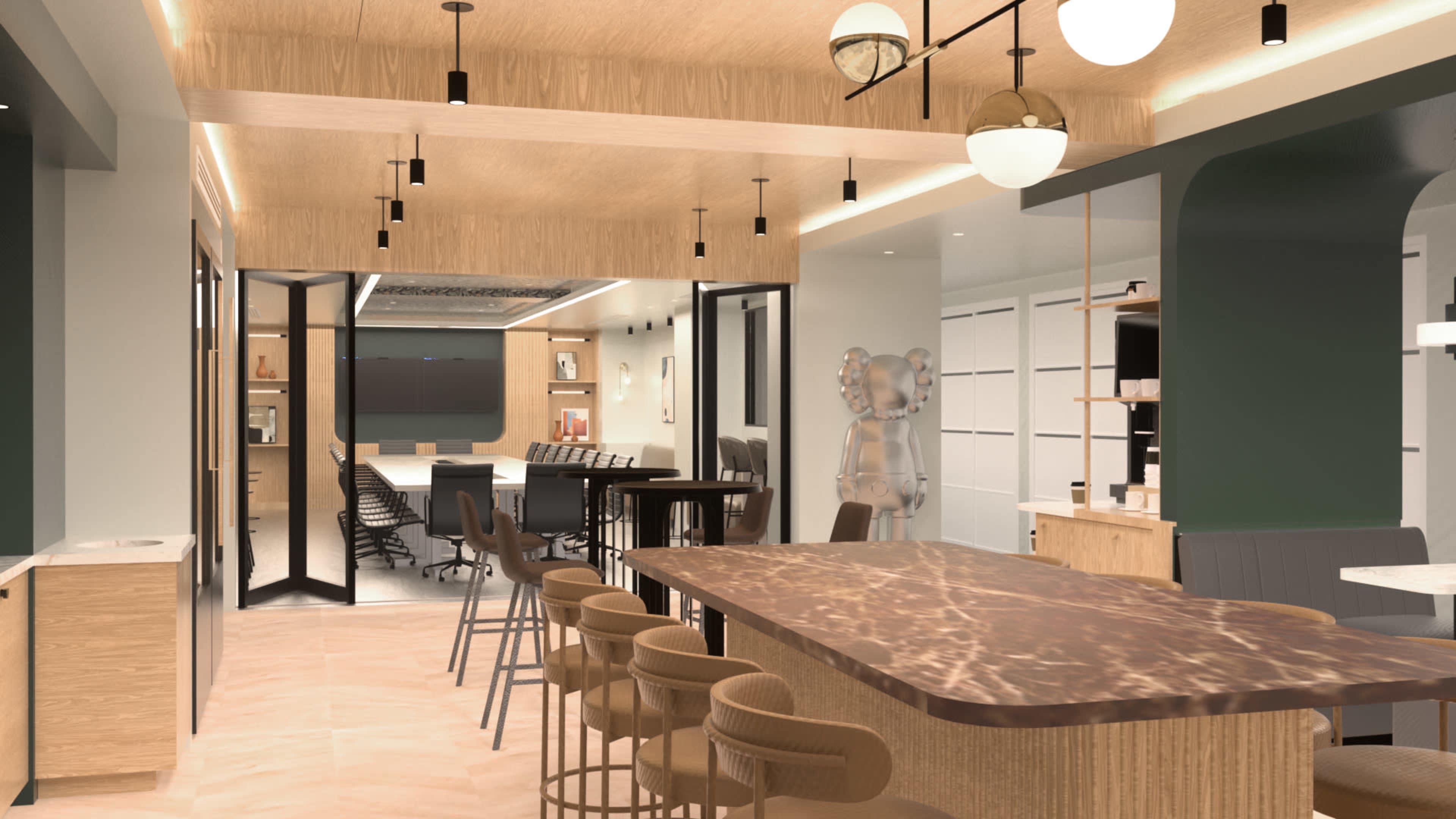 The image shows a modern open-concept workspace featuring a kitchen island with seating, a conference room, and contemporary decor.