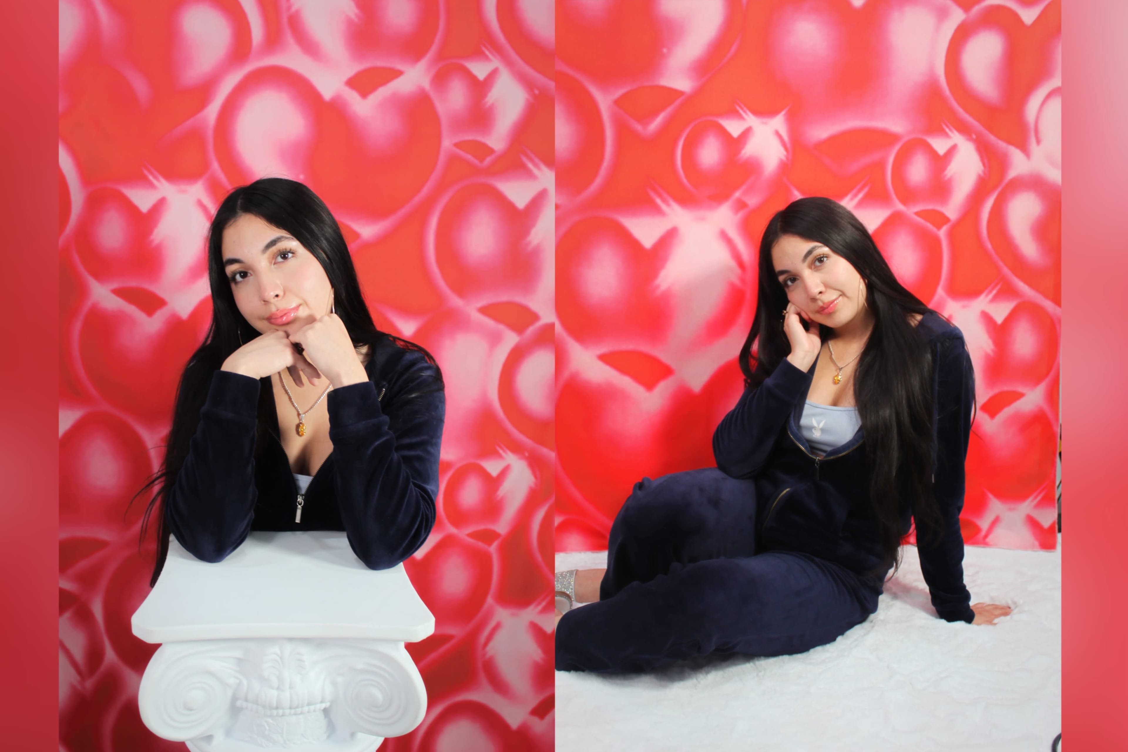 A woman poses with her chin resting on her hand against a brightly colored heart-patterned background.