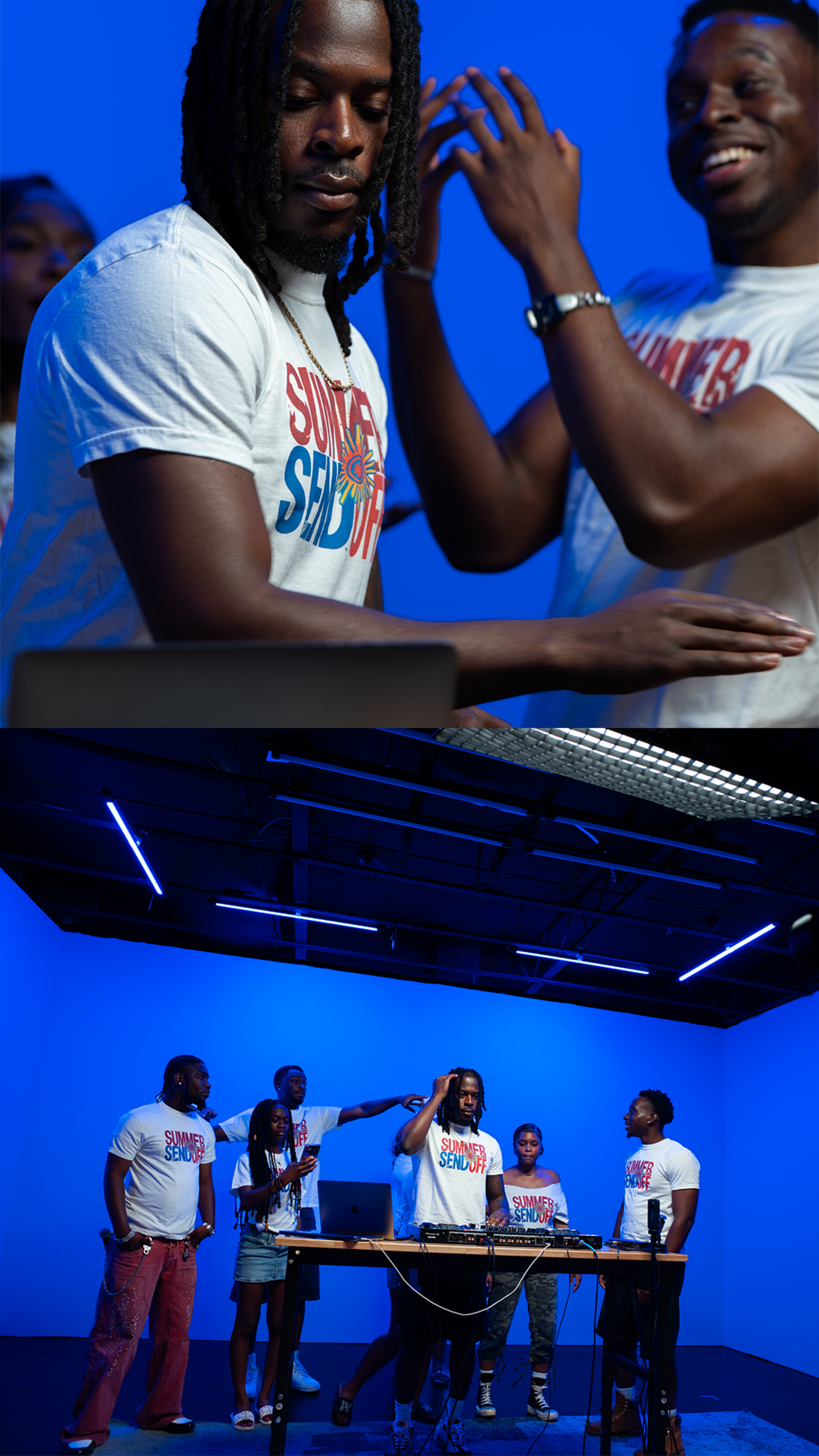 A group of five people in matching T-shirts are interacting around a DJ setup in a studio with blue lighting.
