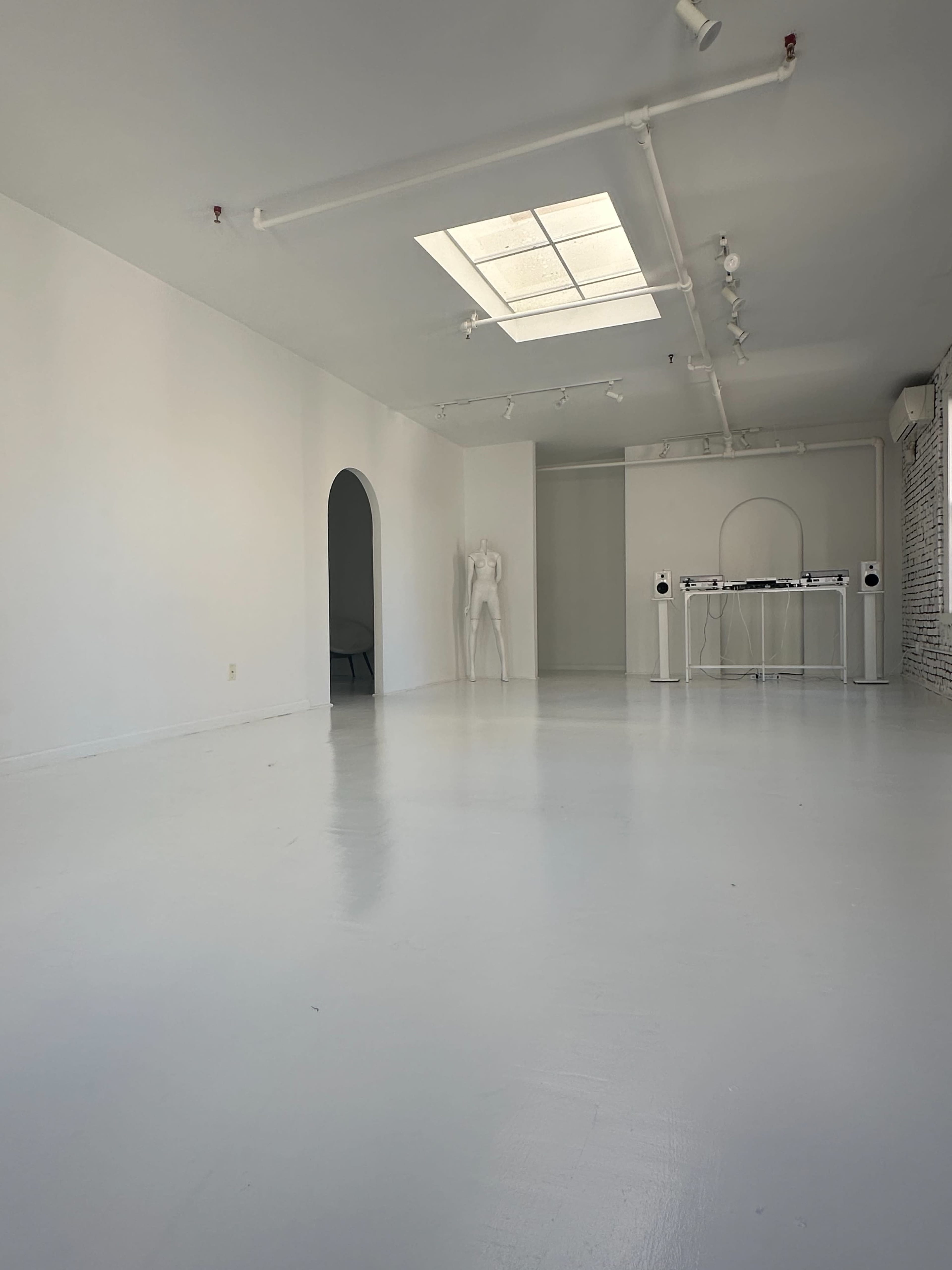 Artistic All-White Loft with Walls of Windows, Skylight & Unique Props Image in Little Italy, New York, NY