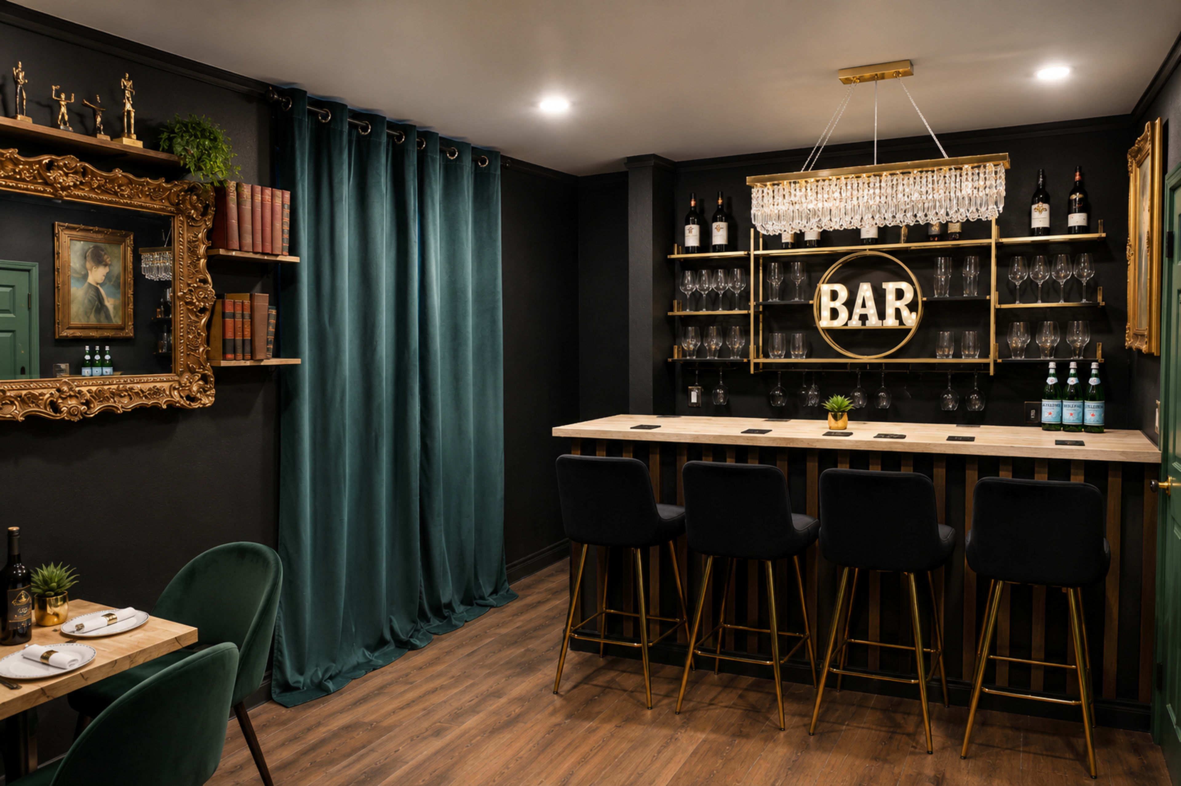 The image shows a modern bar area with a wooden counter, bar stools, a glass rack displaying wine glasses, and decorative elements including a large sign that says "BAR" and a gold-framed mirror.
