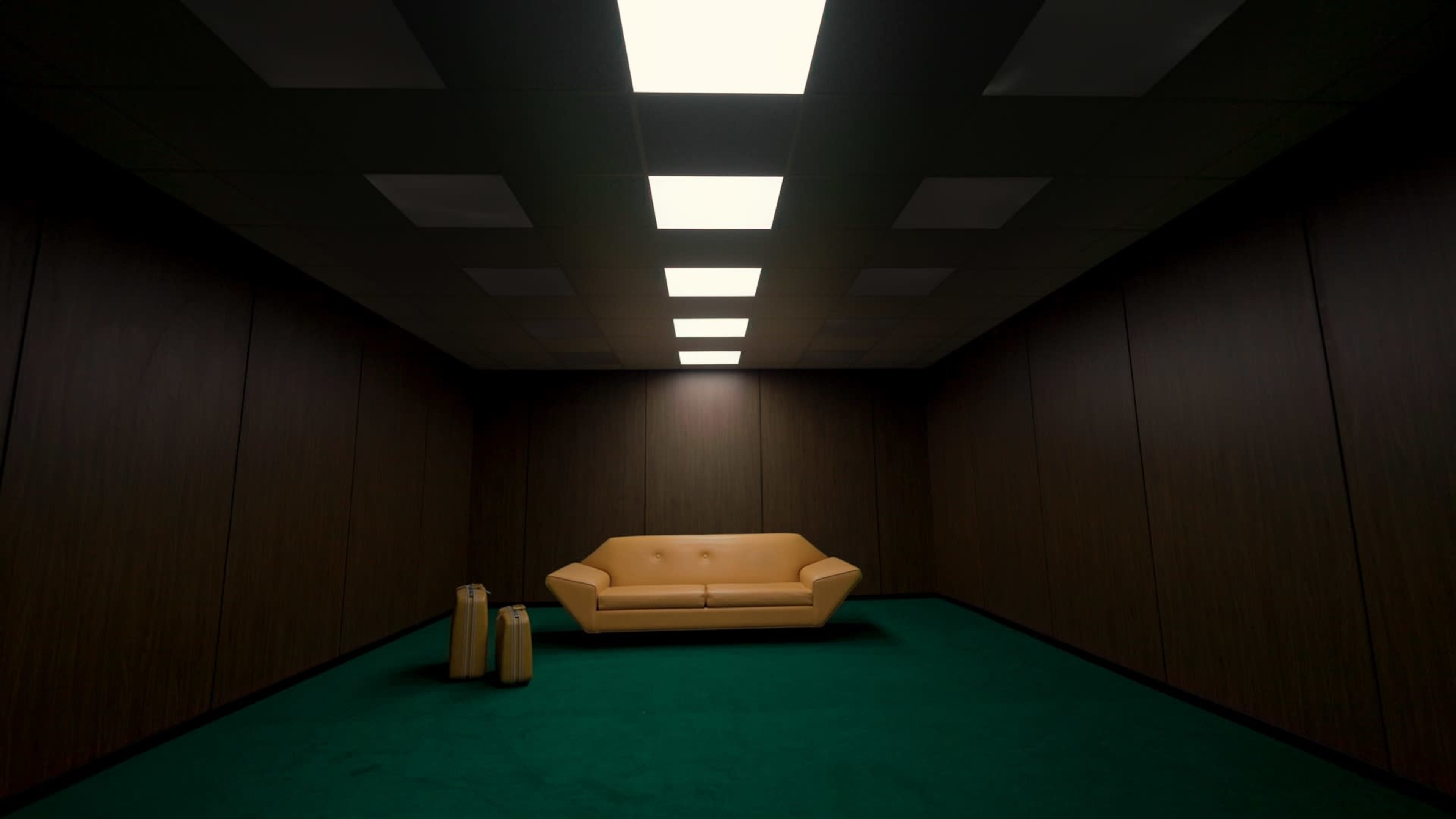 A yellow sofa sits in the center of a dimly lit room with dark wooden walls and a green carpet.