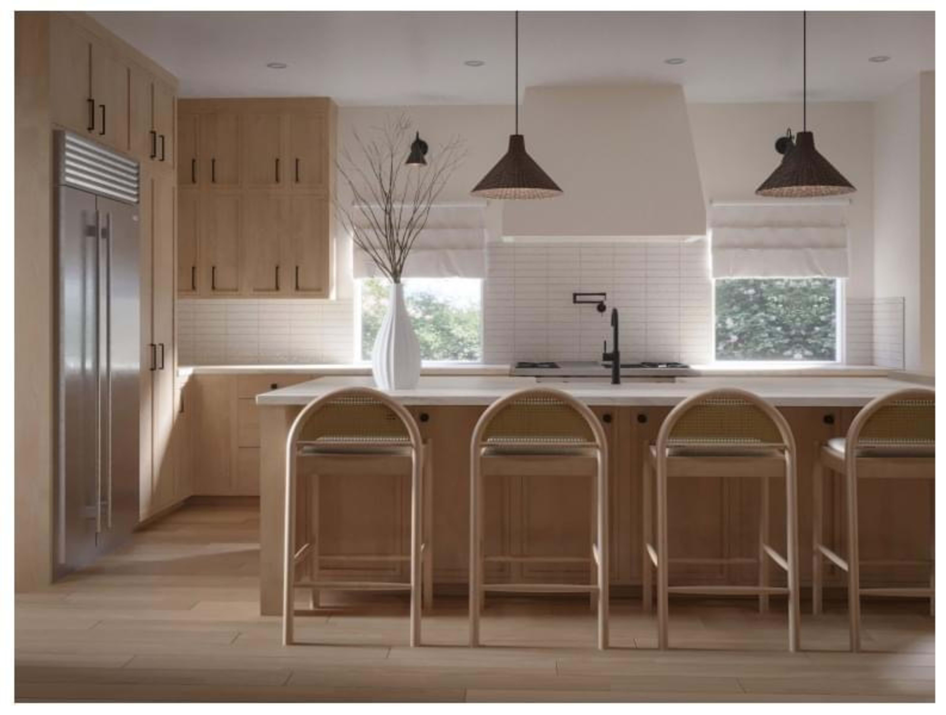 A modern kitchen with light wood cabinetry, a central island with bar stools, and large windows allowing natural light to enter.