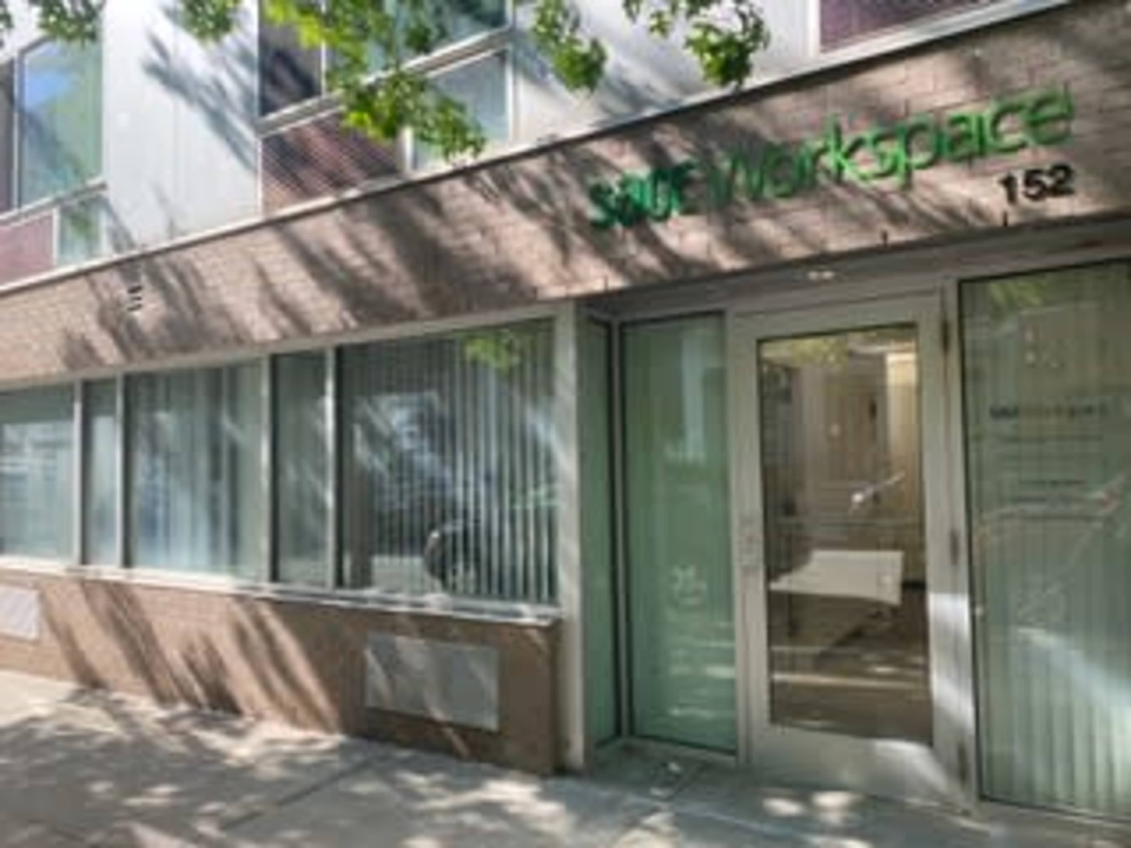 The entrance of a workspace building with large glass doors and the sign "Surf Workspace" prominently displayed.