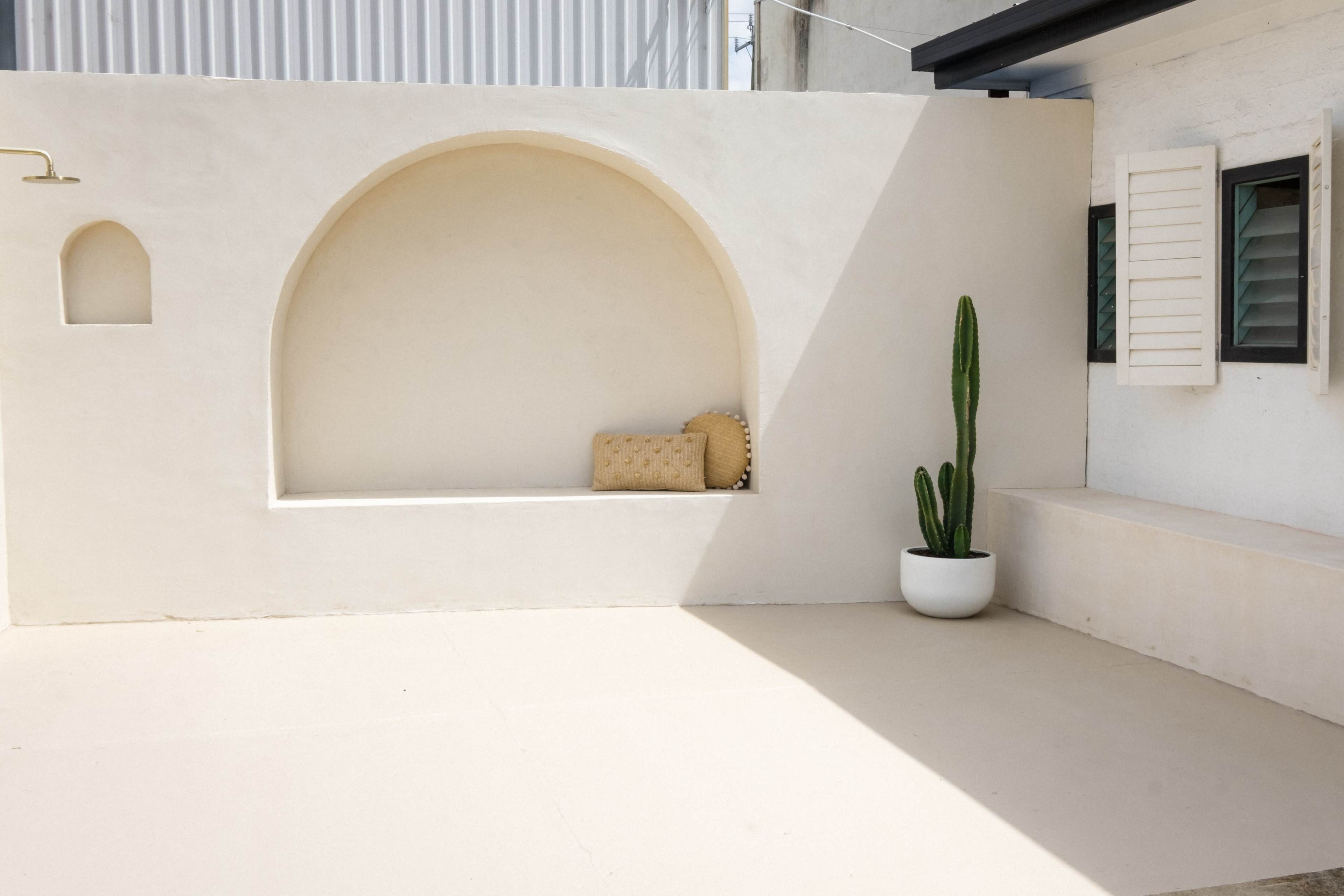 Bali-Inspired Outdoor Courtyard with Rendered Arch and Shower Image in , Airport West, VIC