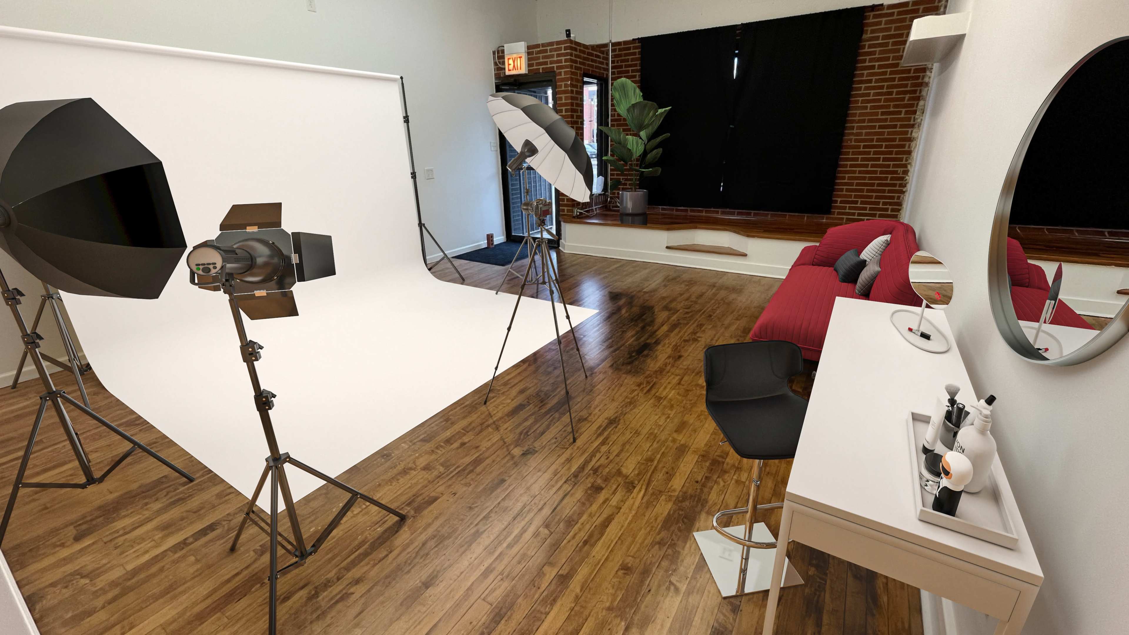 The image shows a photography studio with a white backdrop, two lighting setups, a red couch, and a vanity table with makeup items.
