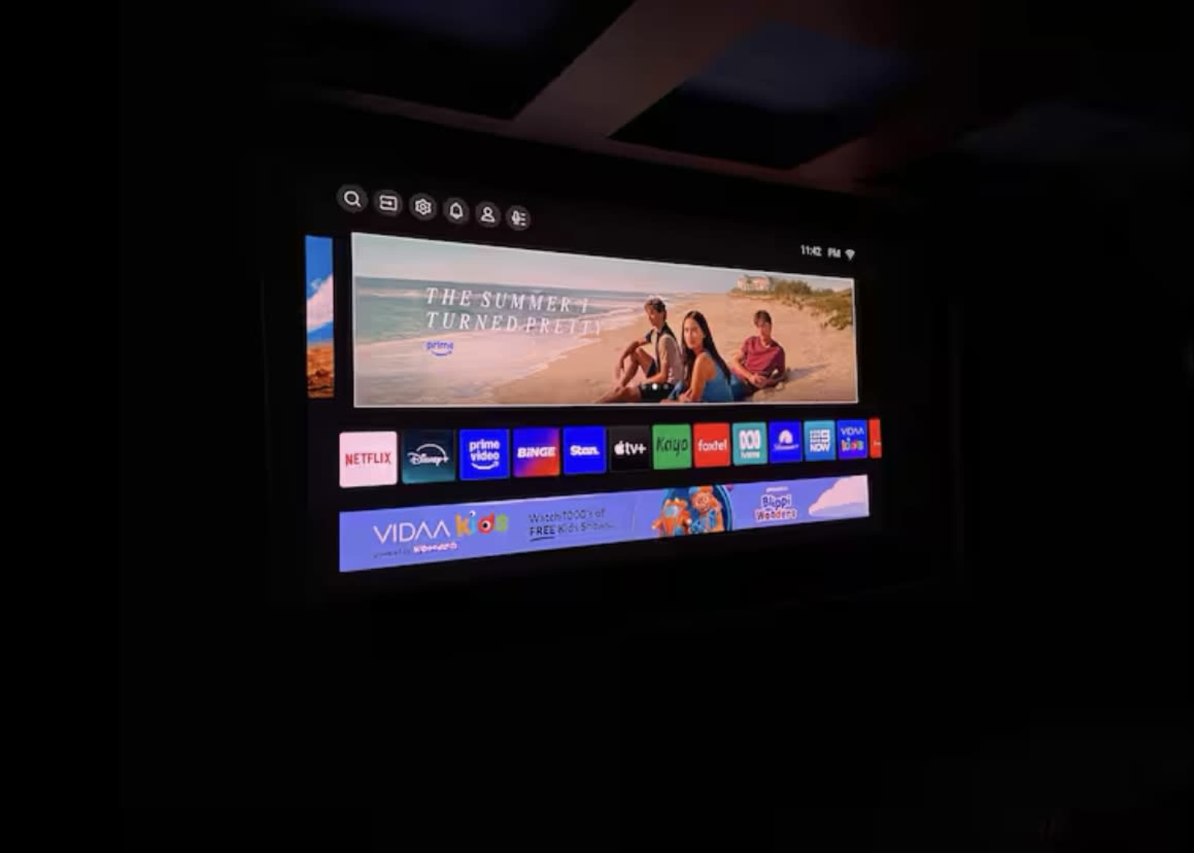 The screen displays a promotional image for a show titled "The Summer I Turned Pretty," alongside various app icons and a dark background.