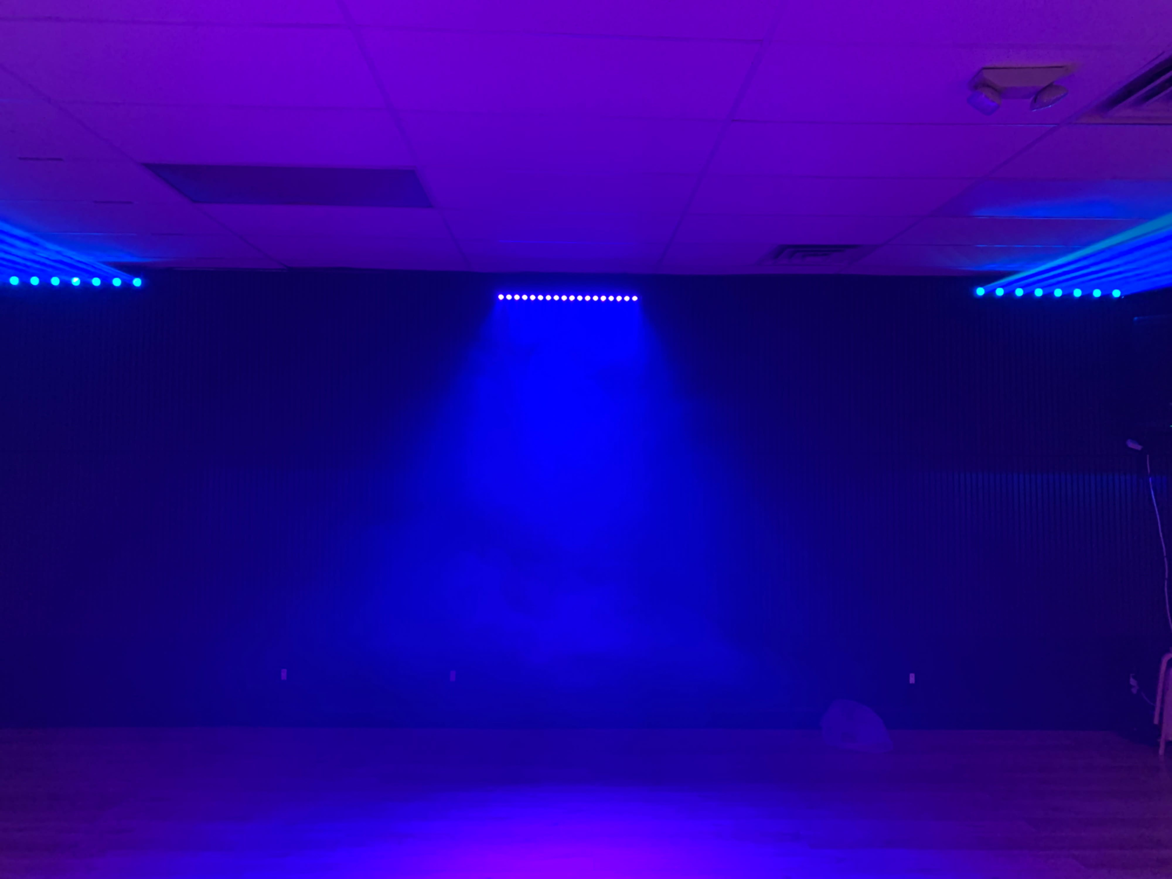 The image shows a dimly lit room with purple lighting and a foggy atmosphere.