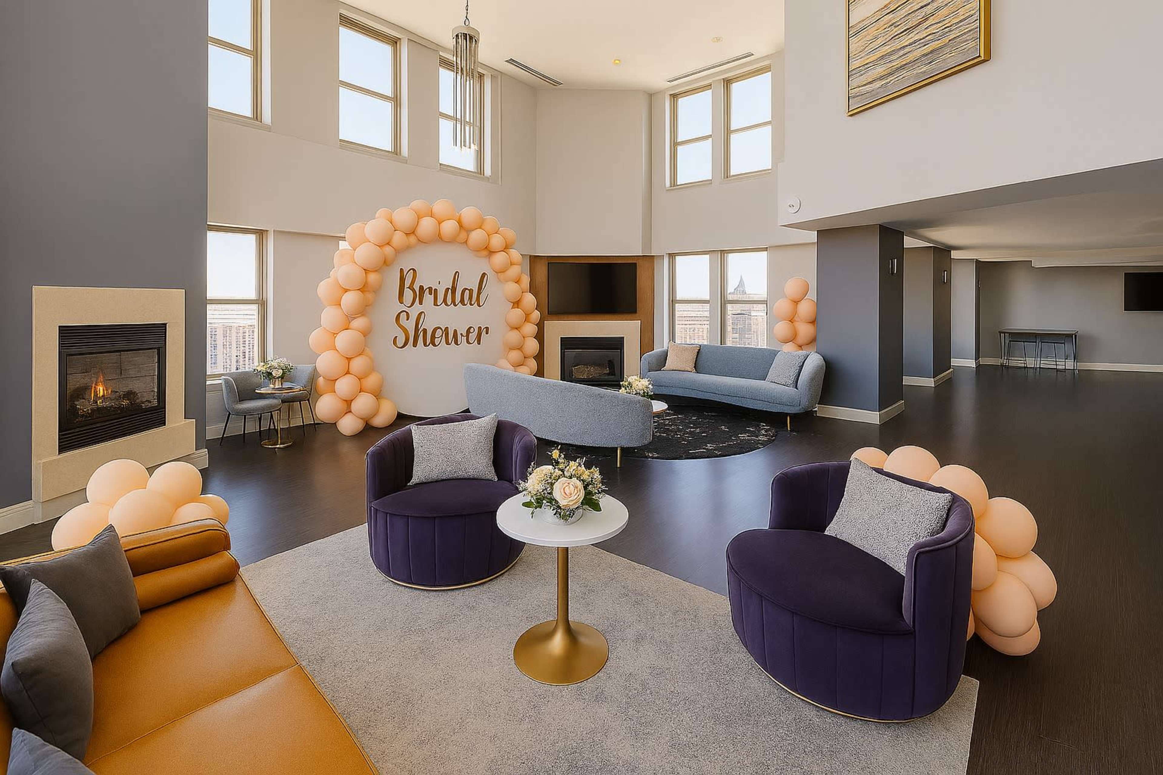 A spacious living area features modern furniture and a decorative balloon arrangement that announces a bridal shower.