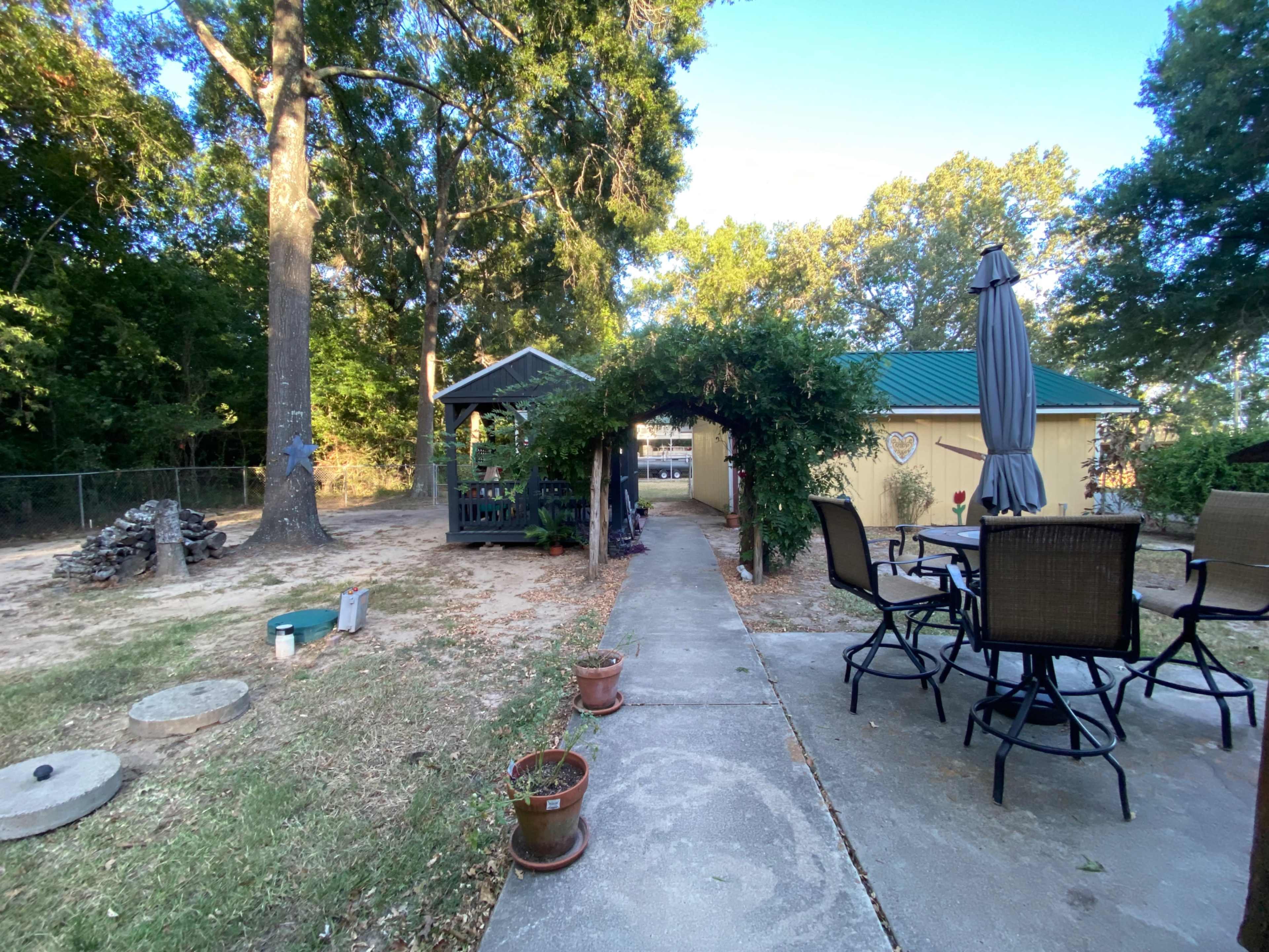 Lake area home with large gazebo and fenced backyard. Image in West Livingston, Livingston, TX