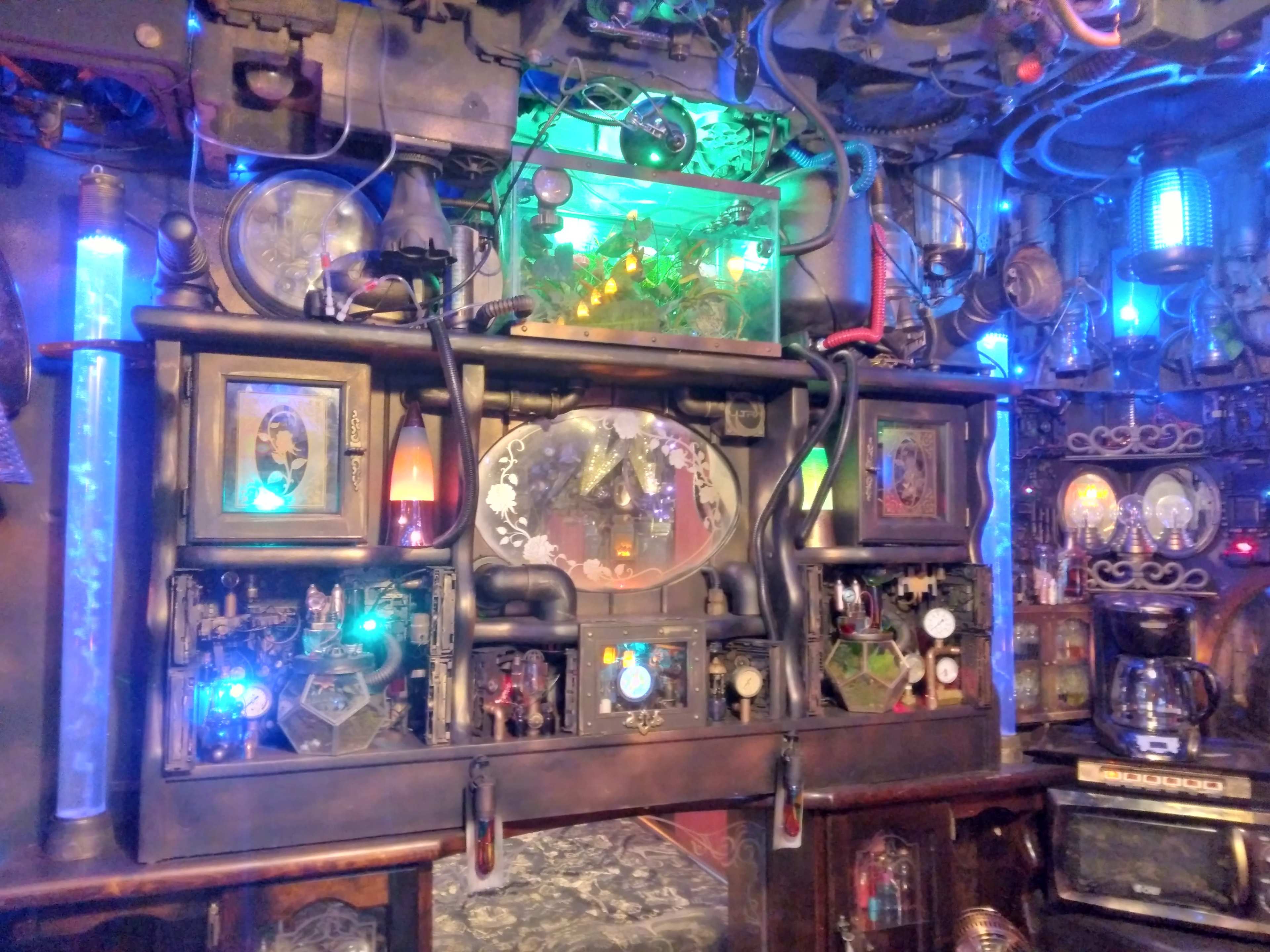 The image features a steampunk-inspired control panel adorned with various gauges, lights, and intricate machinery.