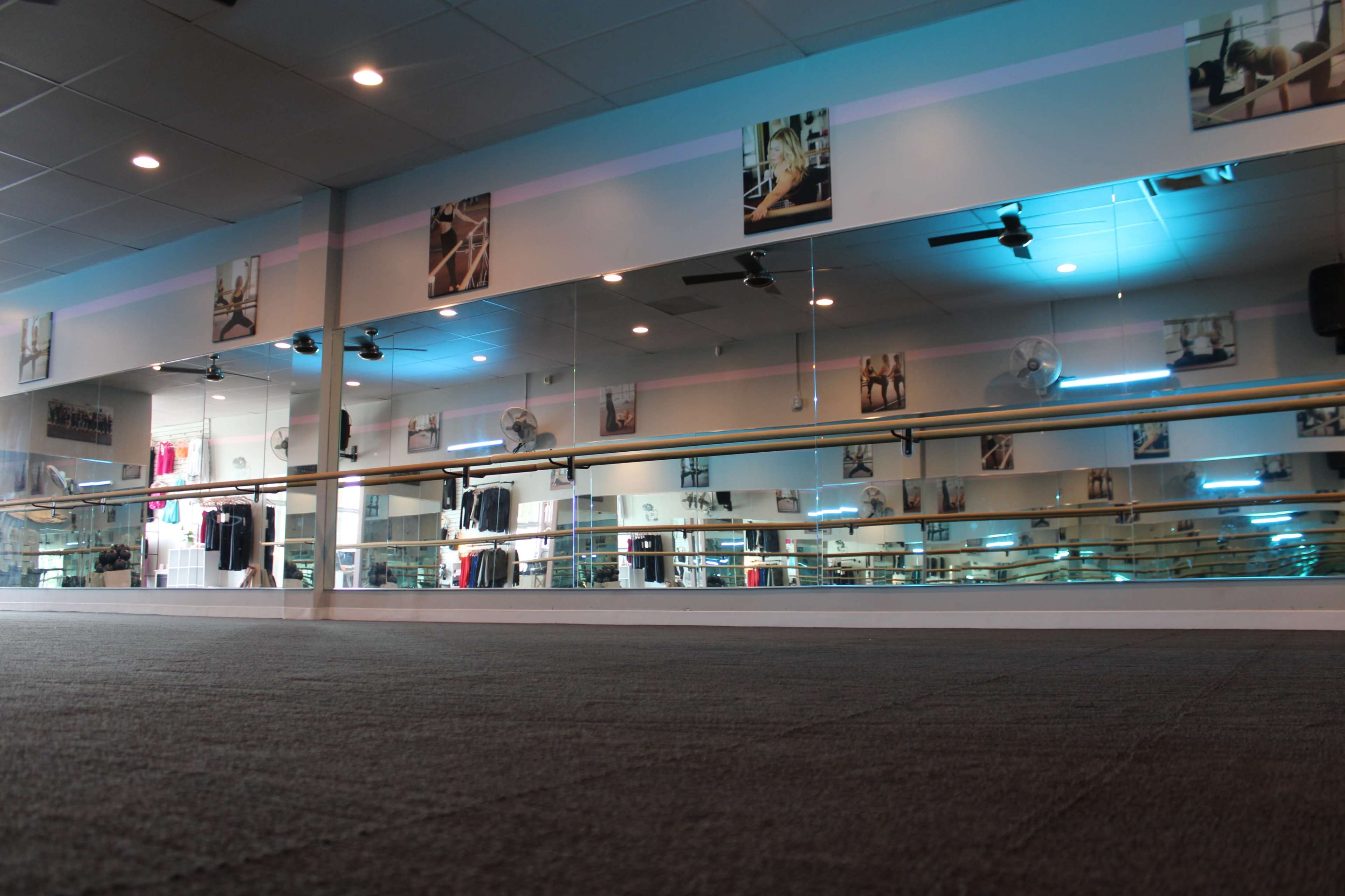 Urban area, open carpeted studio space for fitness, movement, dance, stretching, and more, comfortable and homey yet open, studio space, lobby and office area. Image in Lawrence, Lawrence, KS