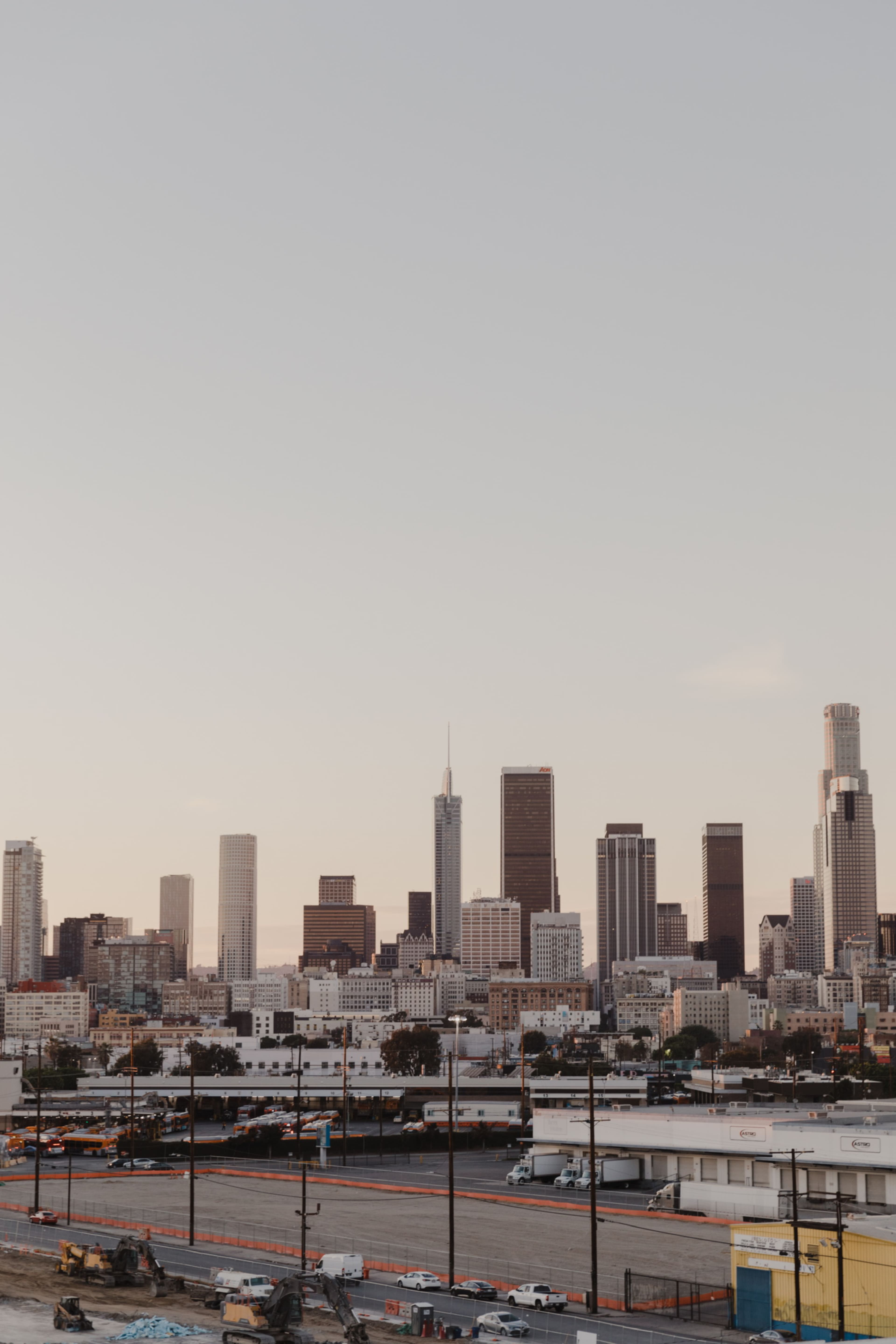A skyline of downtown Los Angeles with various high-rise buildings against a clear sky.