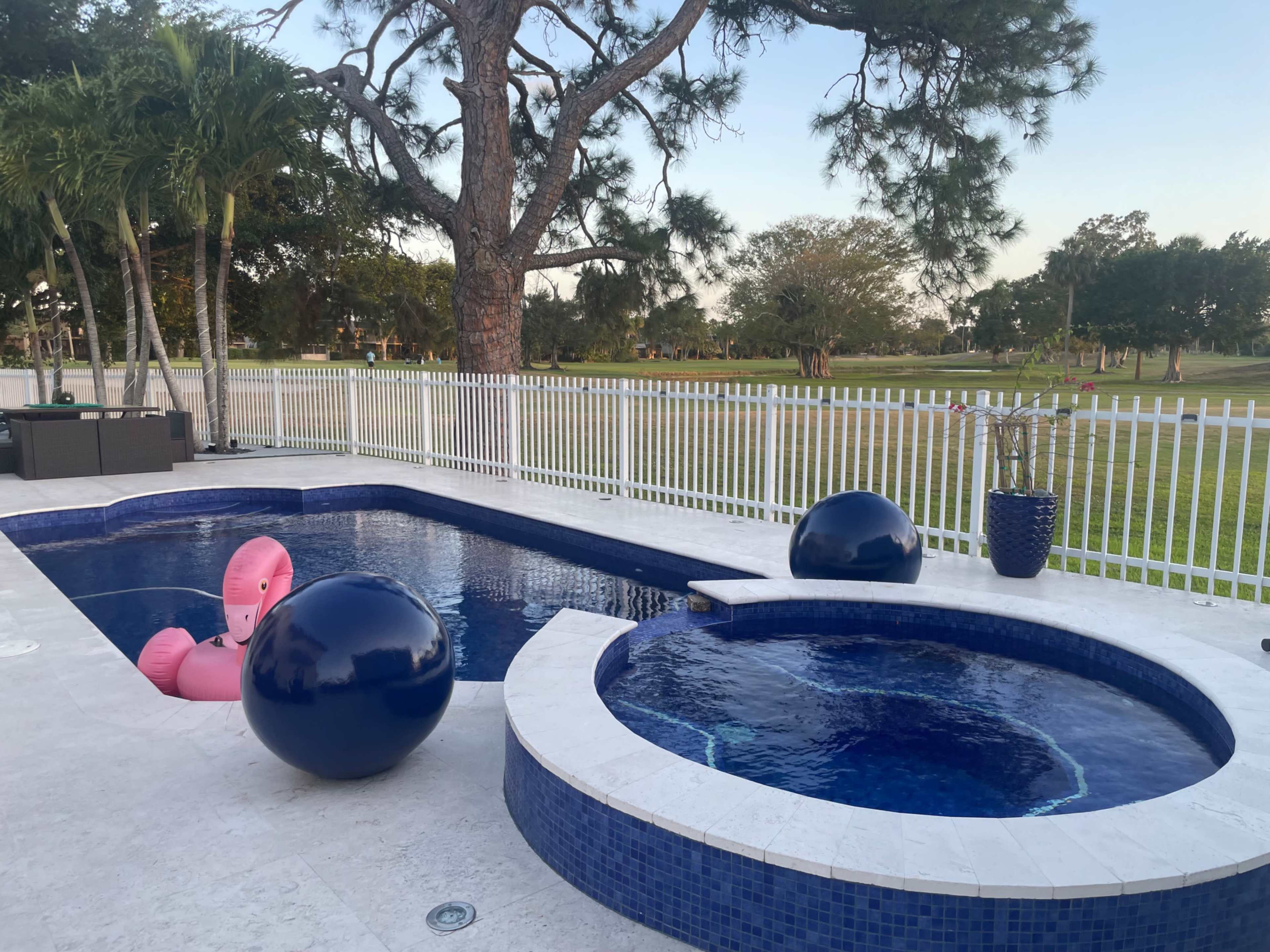 Country club, suburban, outdoor area with pool. Golf course view, roomy area with plenty of seating. Image in Country Club, Miami, FL