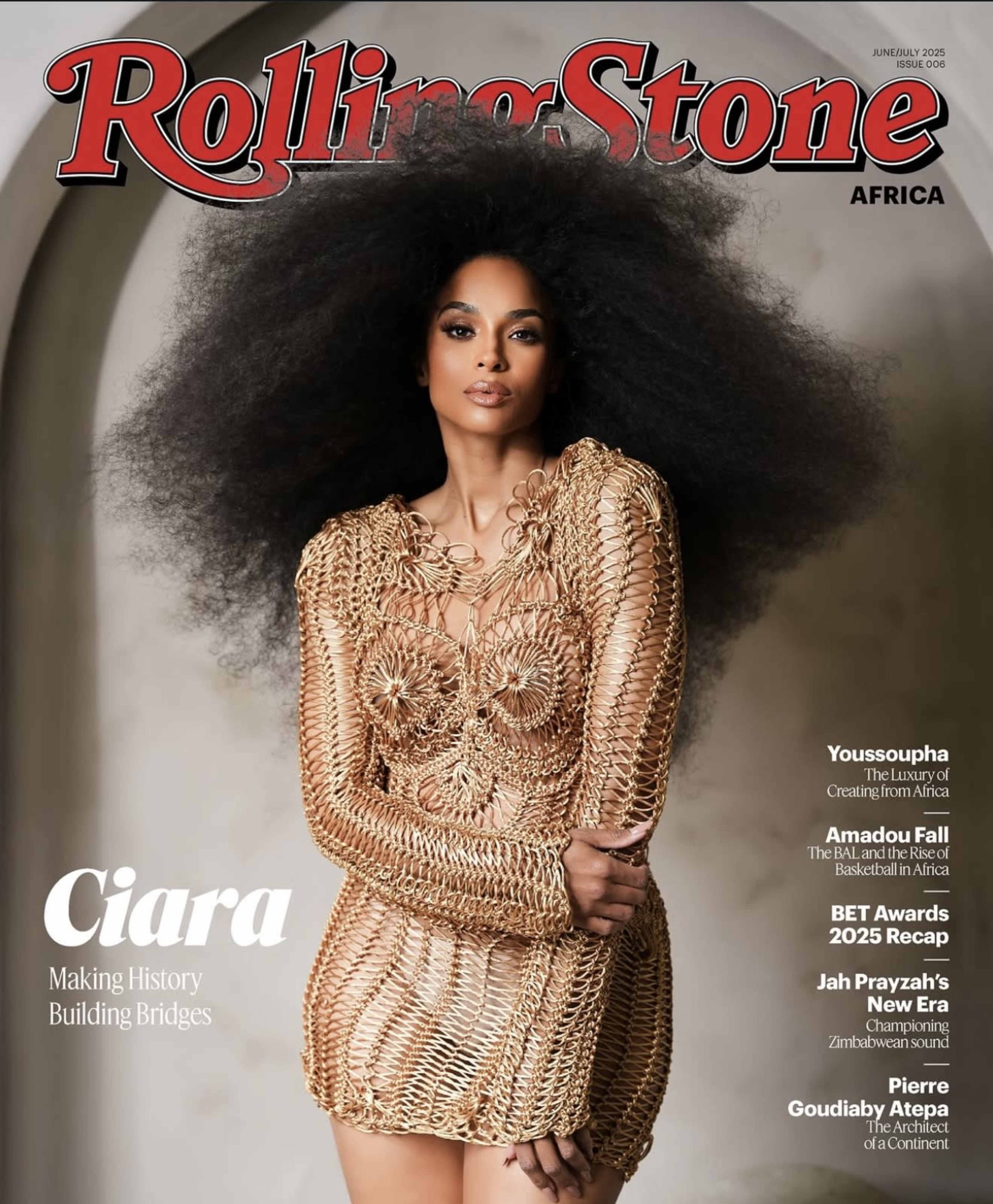 The image features a woman with voluminous hair wearing a distinctive golden dress made of intricate patterns on the cover of Rolling Stone Africa.